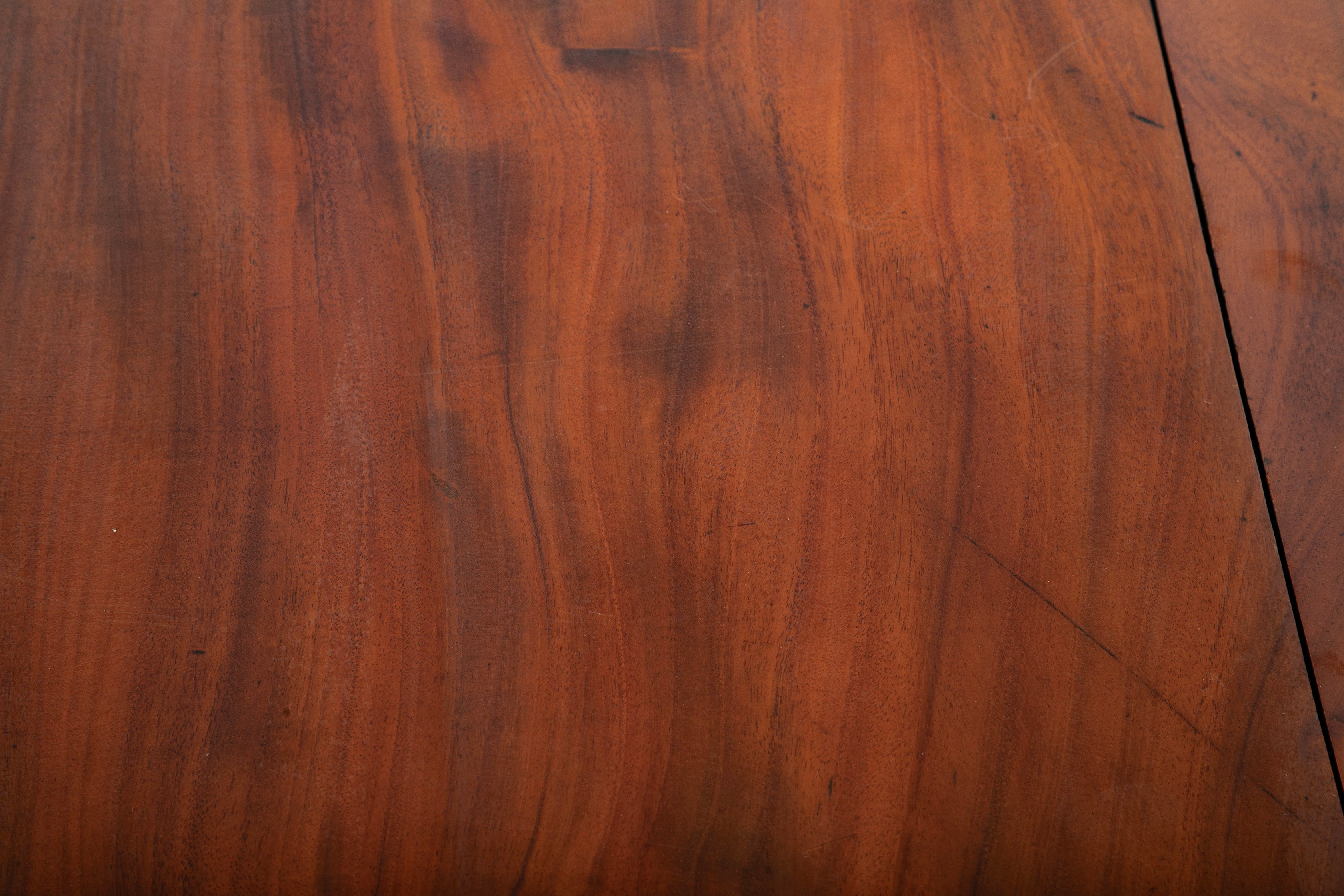 A George III Two Part Tilting Demi Lune Section Mahogany Dining Table