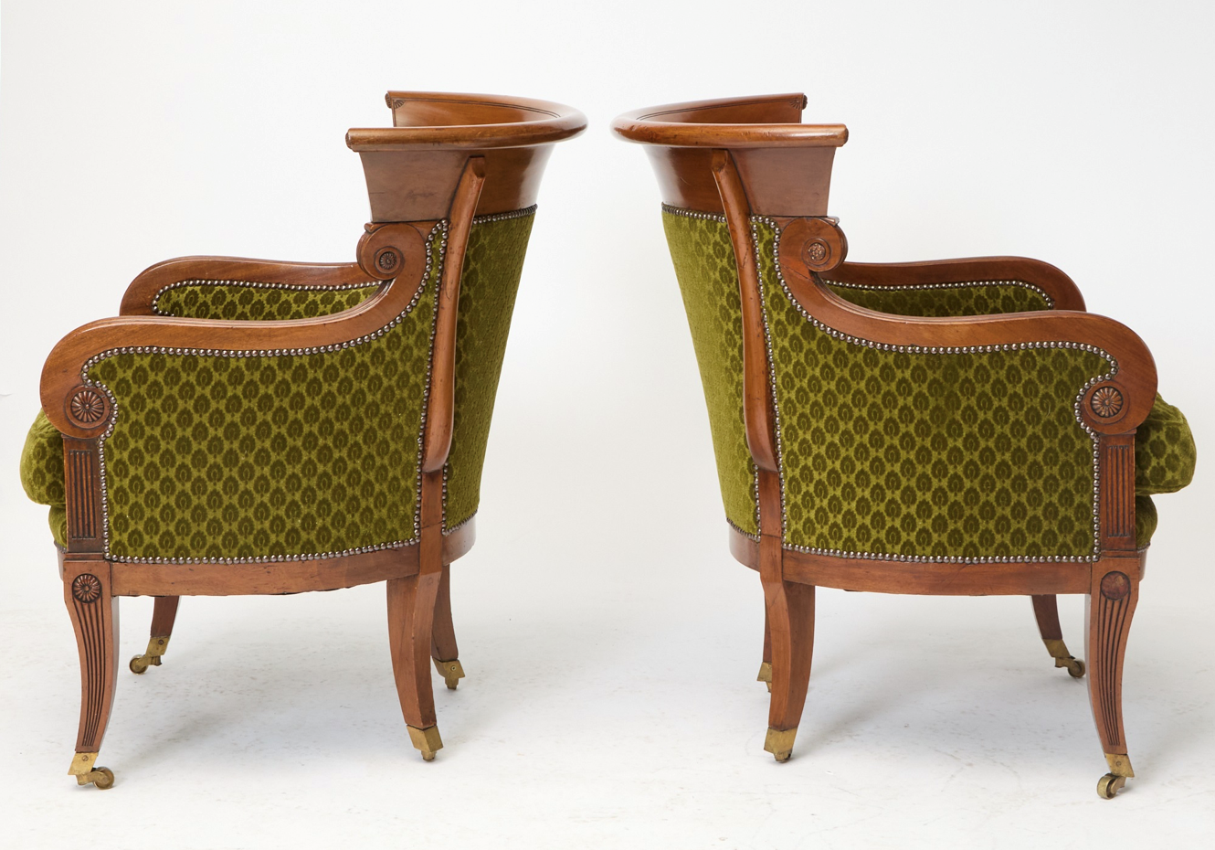 Pair of English Regency Mahogany Bergeres in the Manner of George Oakley