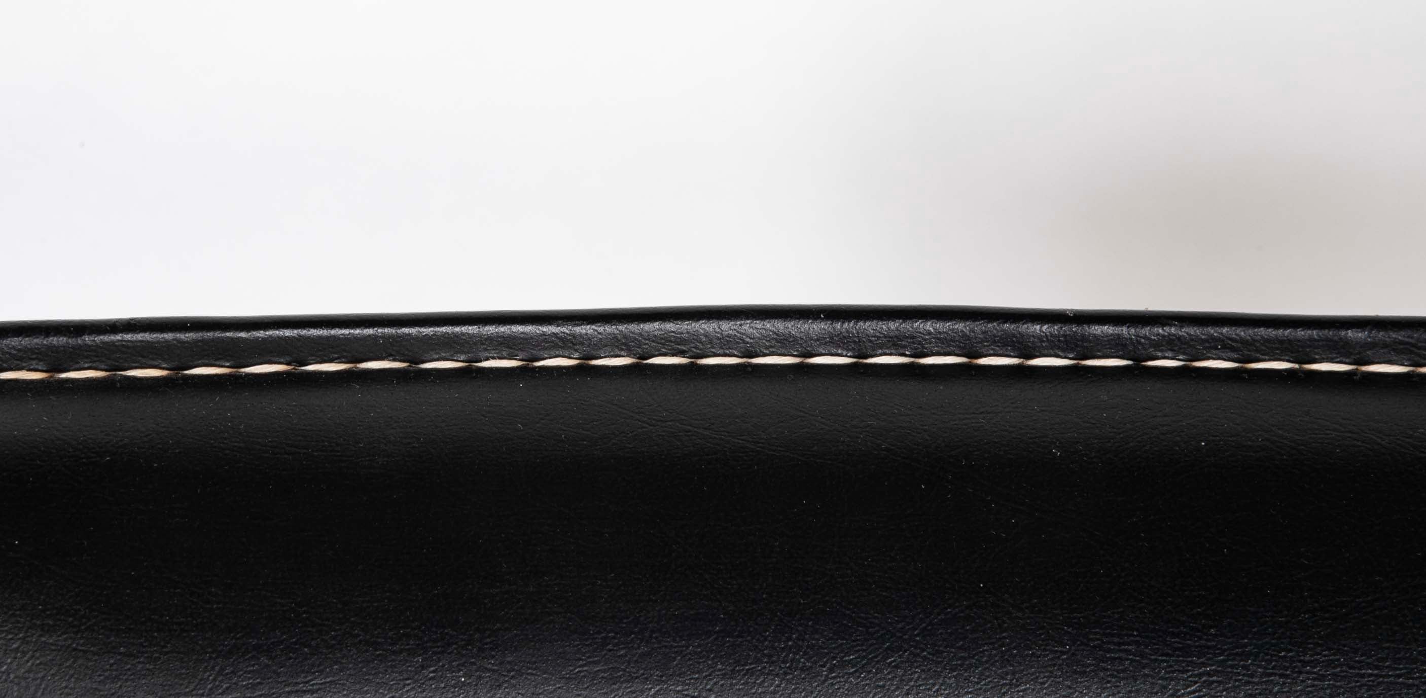 A Black Vinyl Wrapped Armchair Attributed to Jacques Adnet
