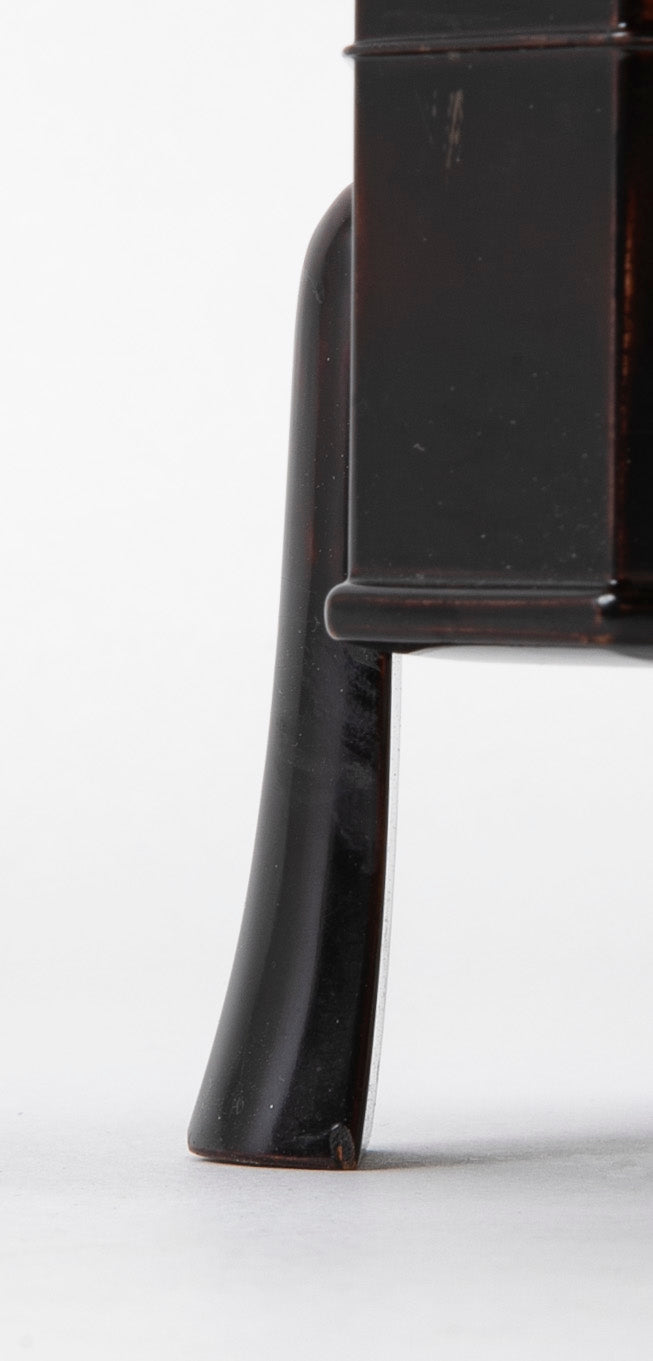 A Japanese Black Lacquer Faceted Covered Box on Four Splayed Feet