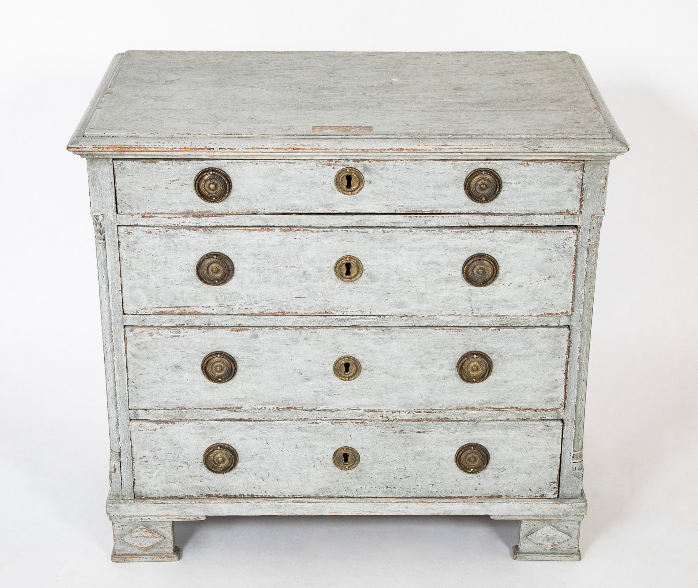 A Louis XVI White Painted Four Drawer Chest