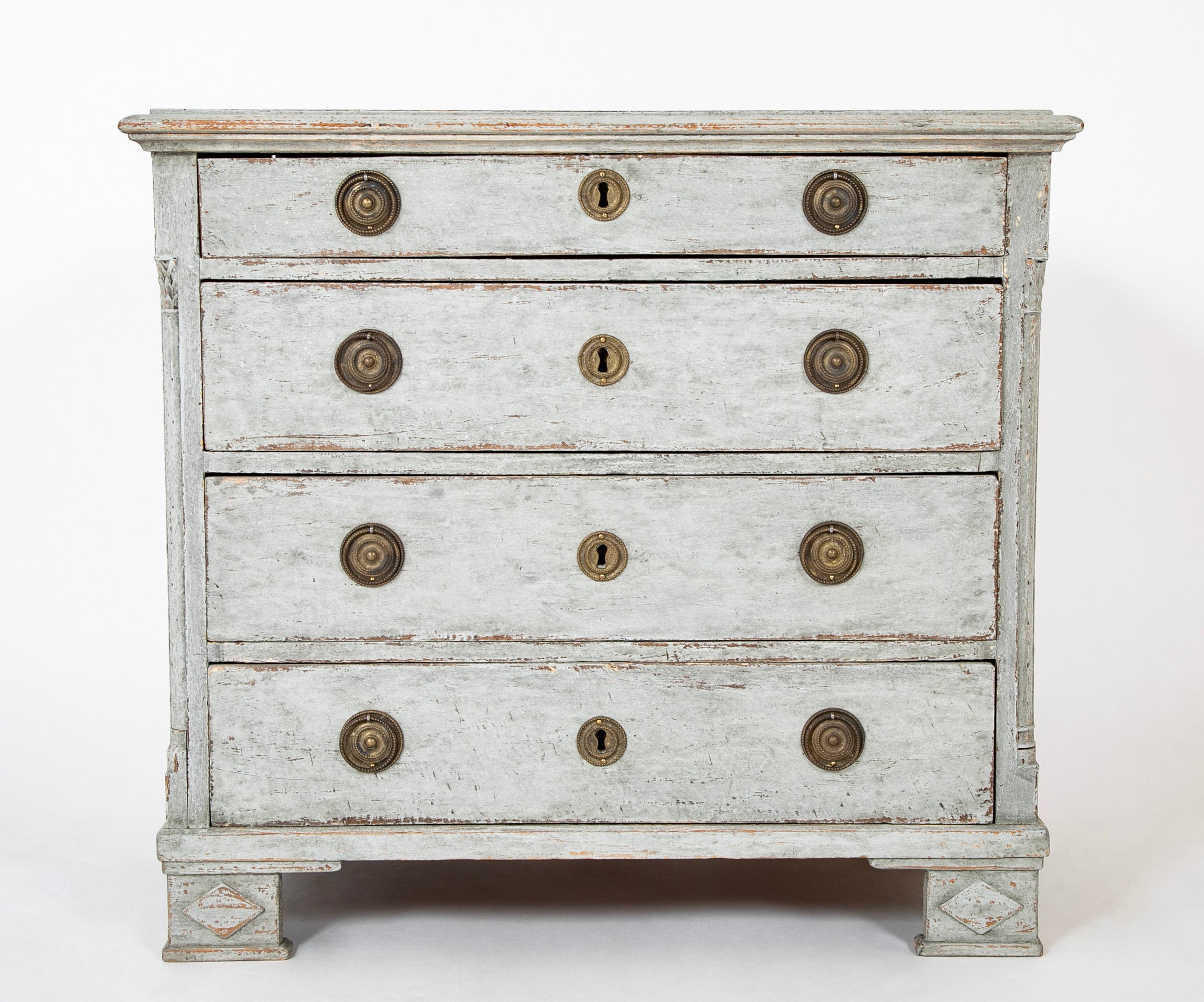 A Louis XVI White Painted Four Drawer Chest