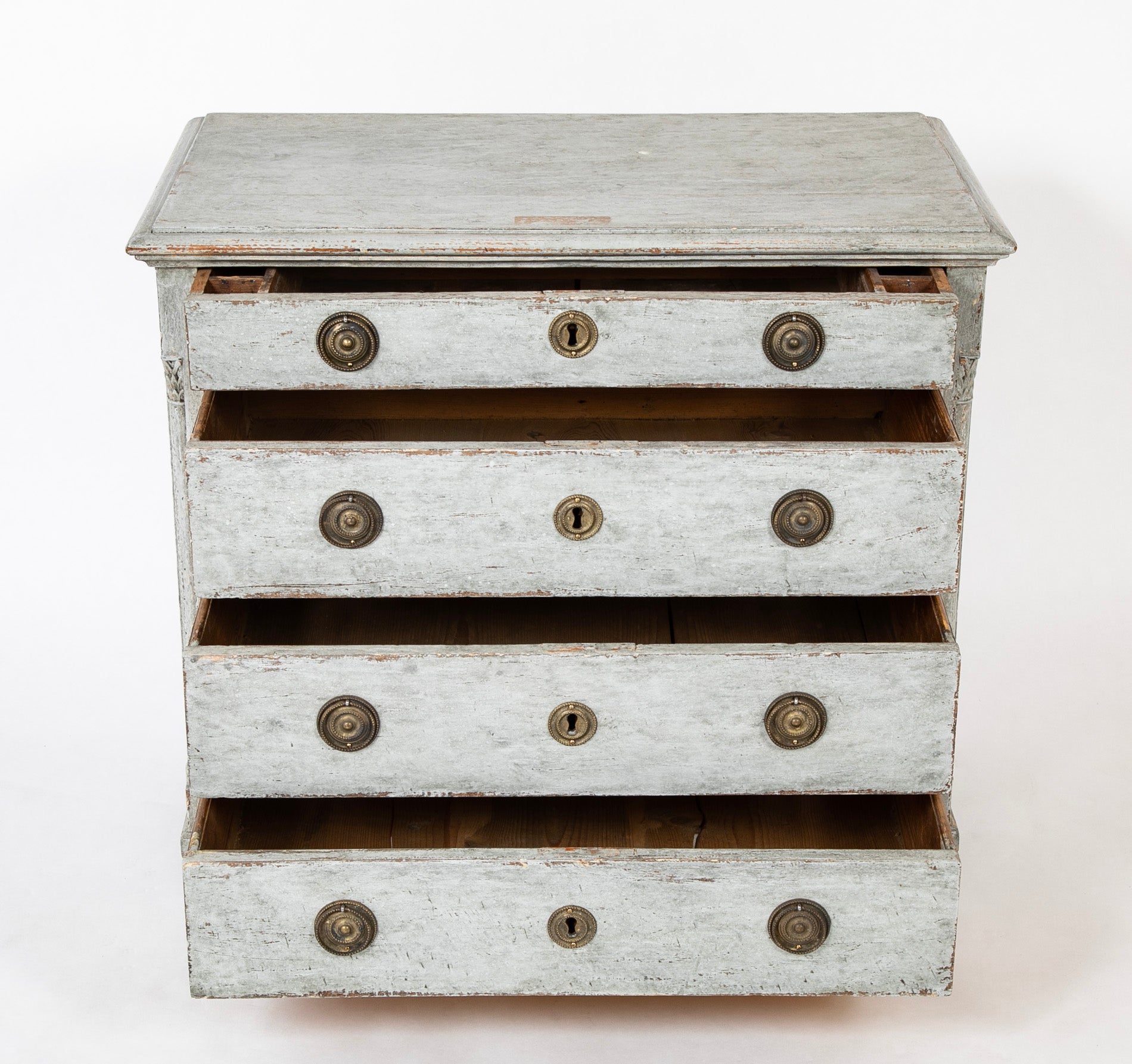A Louis XVI White Painted Four Drawer Chest