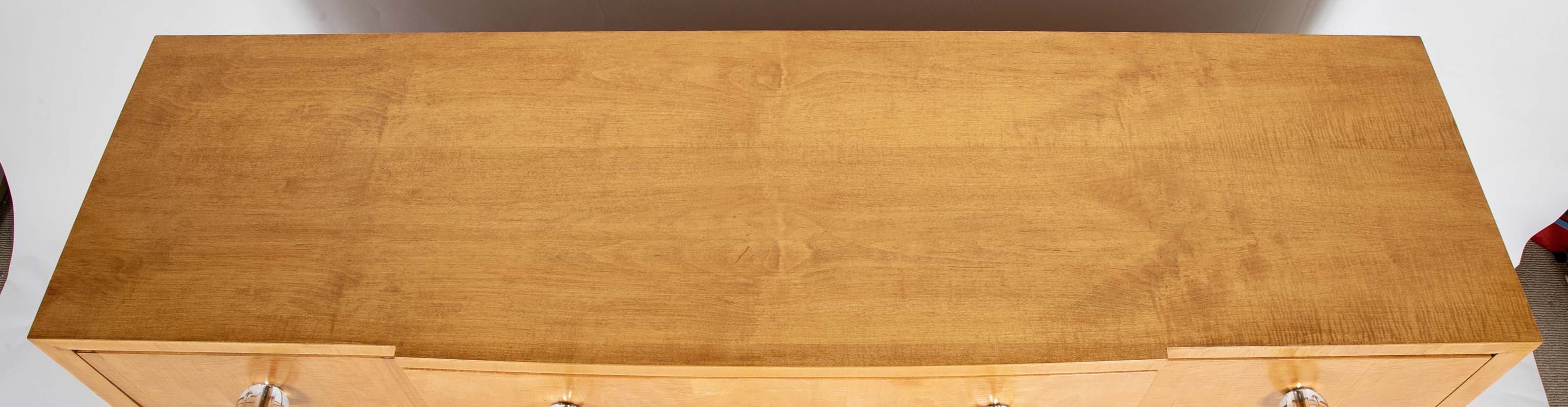 A French Sycamore Veneered Chest of Drawers Attributed to Andre Arbus