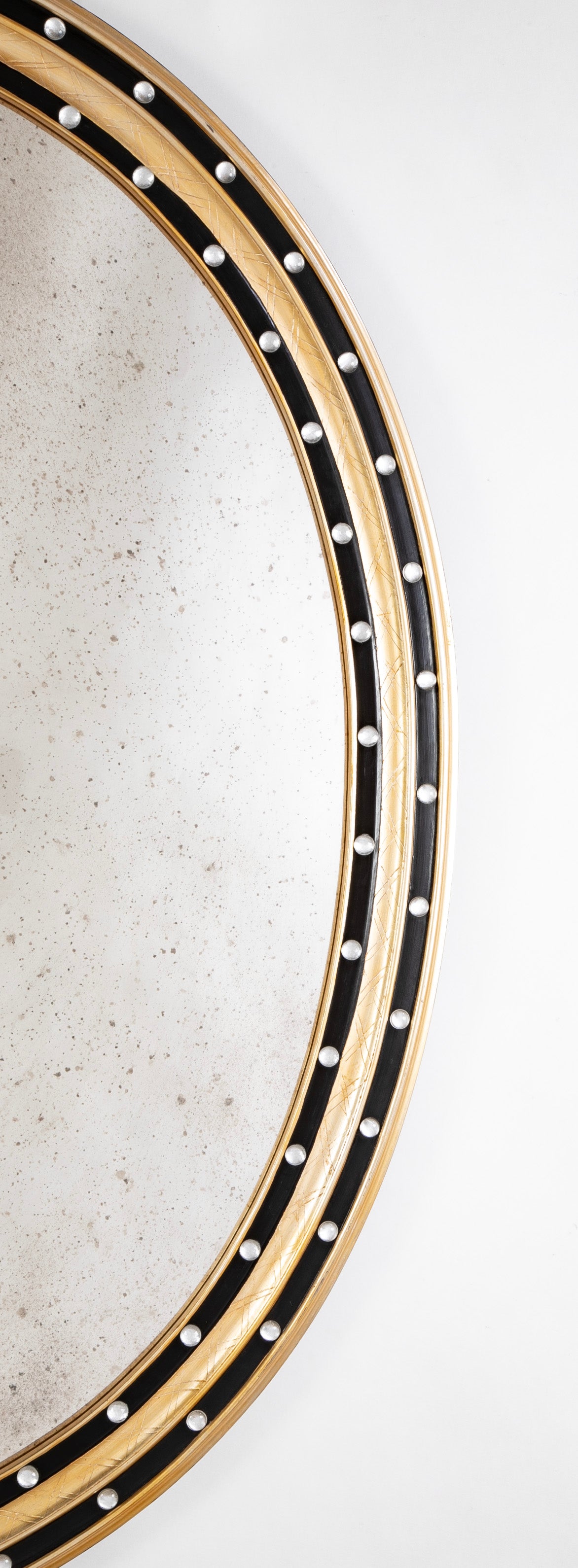 An Irish Ebonized & Parcel Gilt Oval Mirror with Faceted Bead Decoration