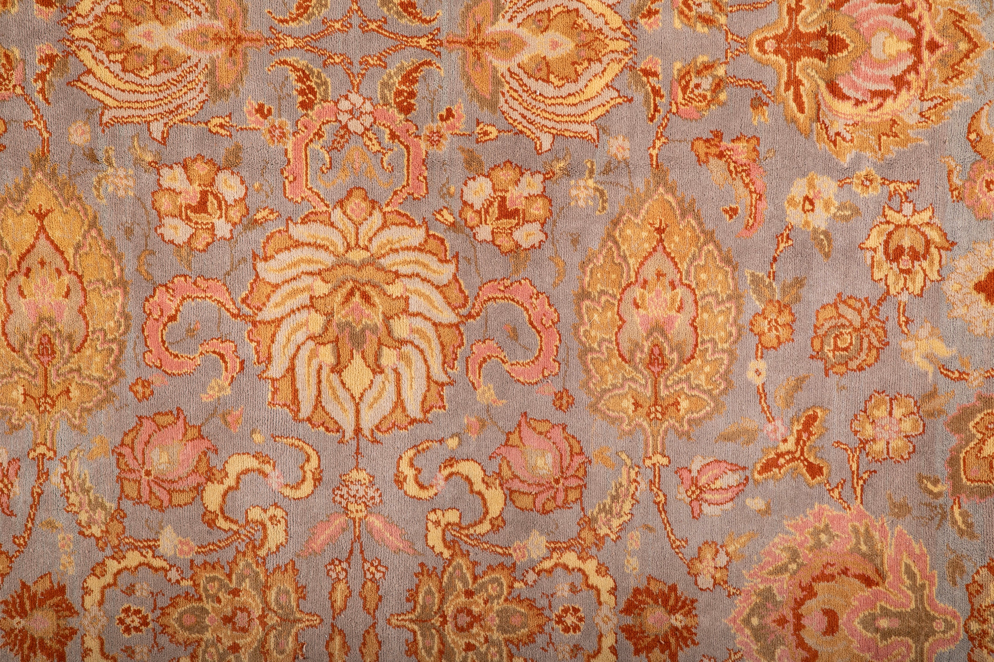 A Spanish Wool Carpet Having Floral Motifs