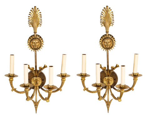 A Pair of Cast Brass Sconces in the Form of an Arrow with Face