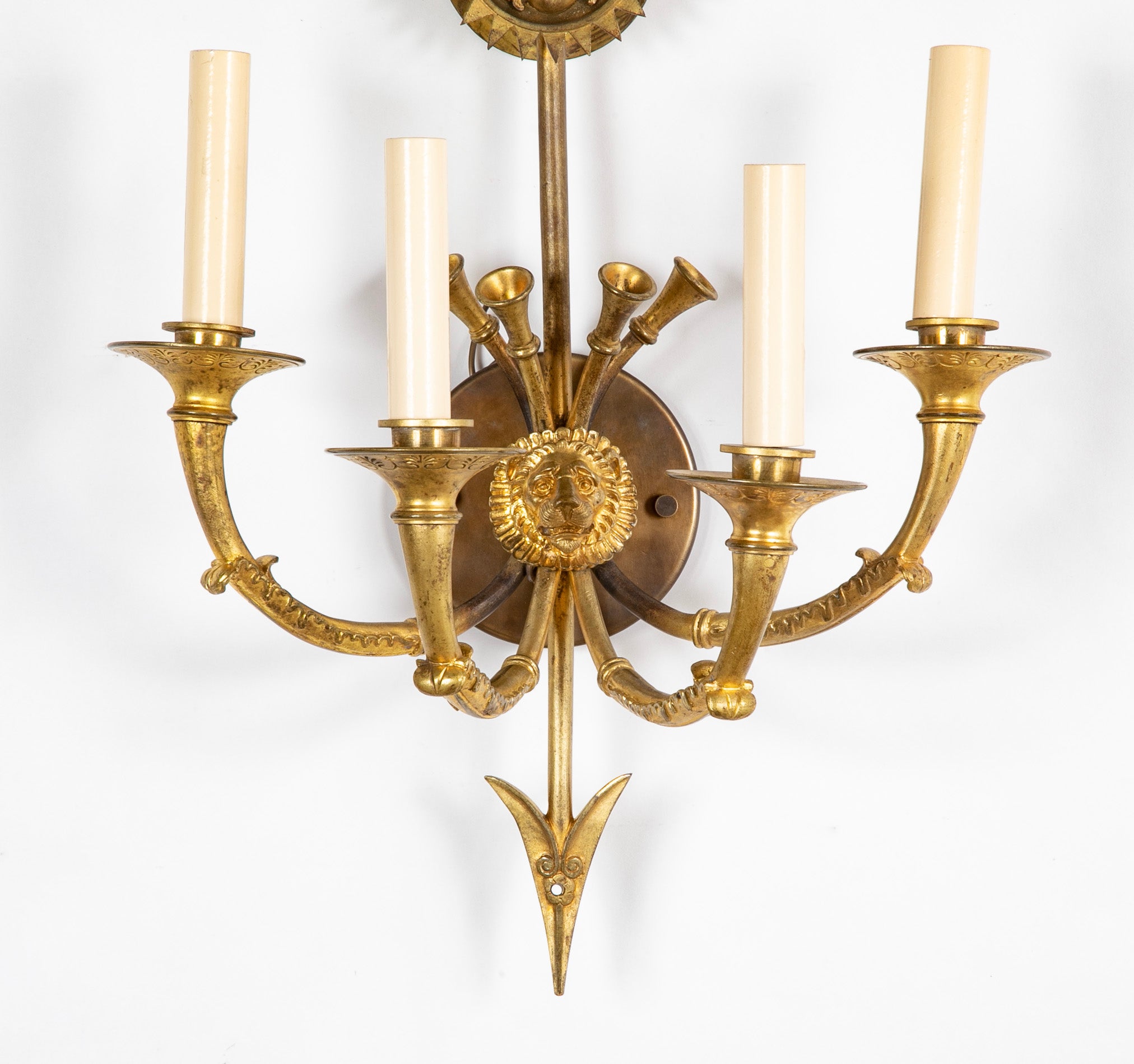 A Pair of Cast Brass Sconces in the Form of an Arrow with Face