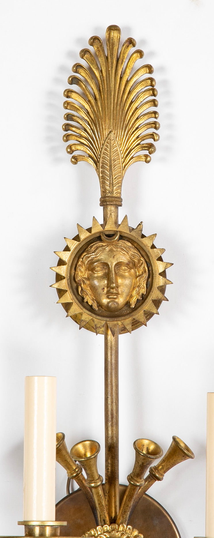 A Pair of Cast Brass Sconces in the Form of an Arrow with Face