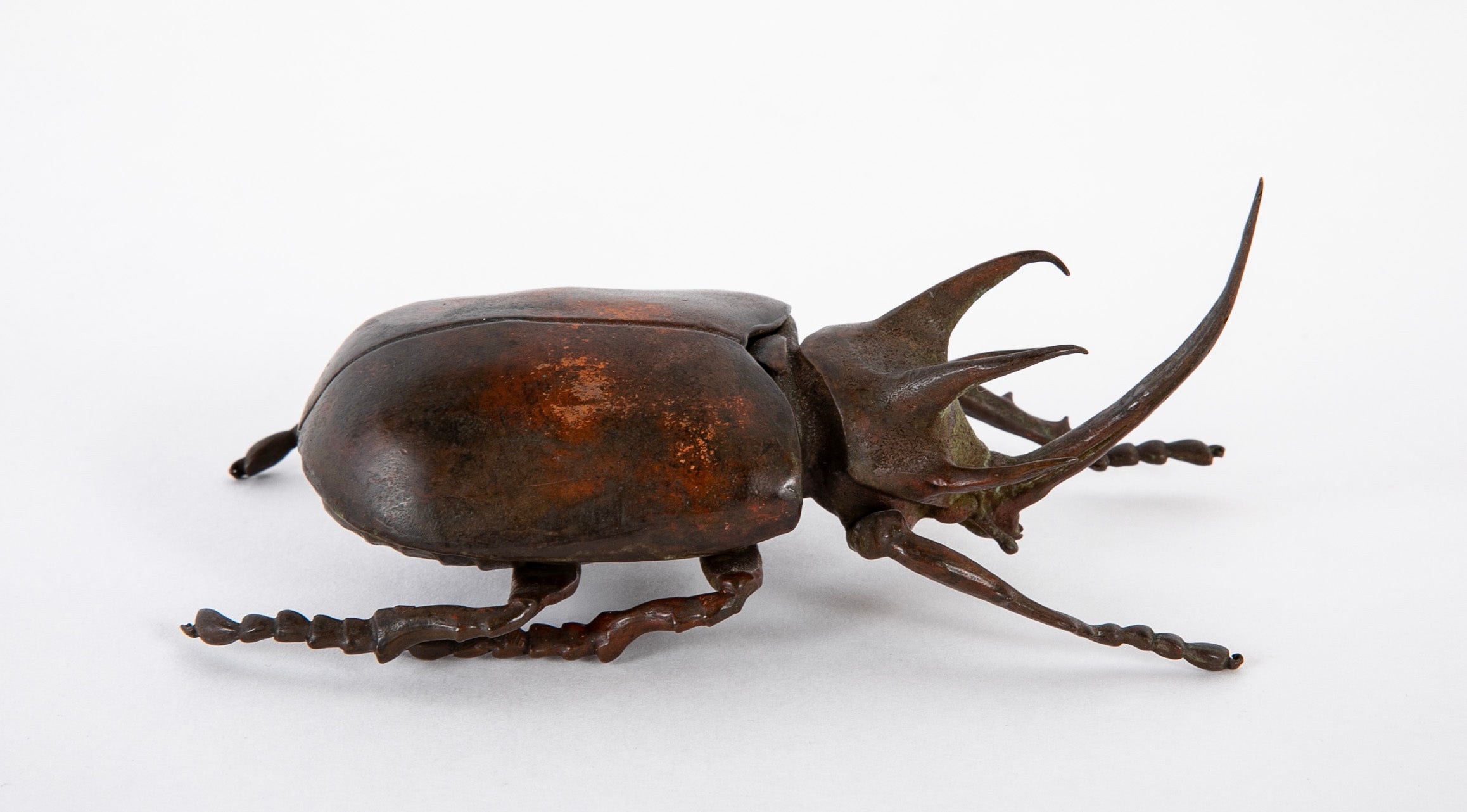 A Japanese Patinated Bronze Rhinoceros Beetle with Opening Back