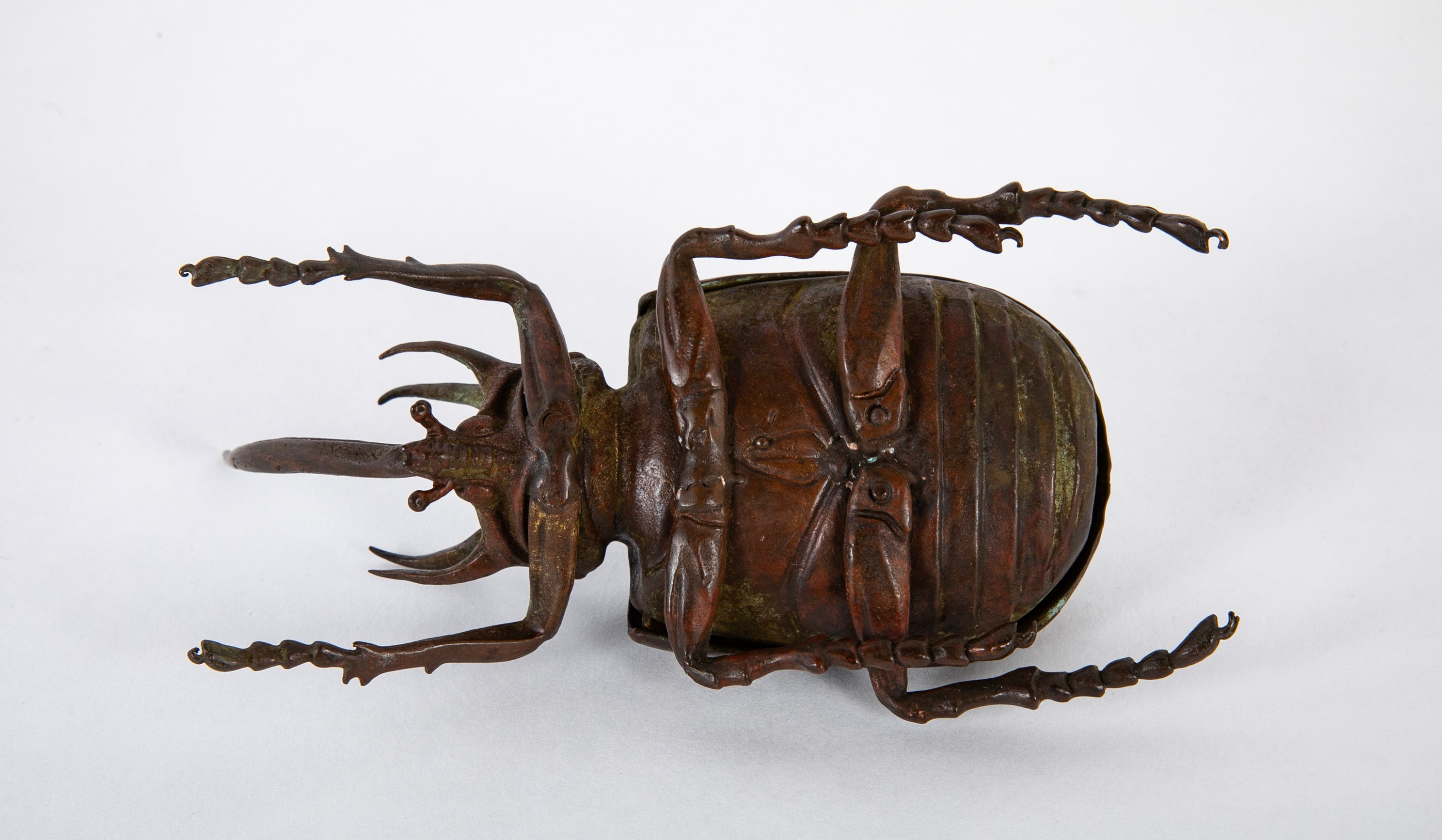 A Japanese Patinated Bronze Rhinoceros Beetle with Opening Back