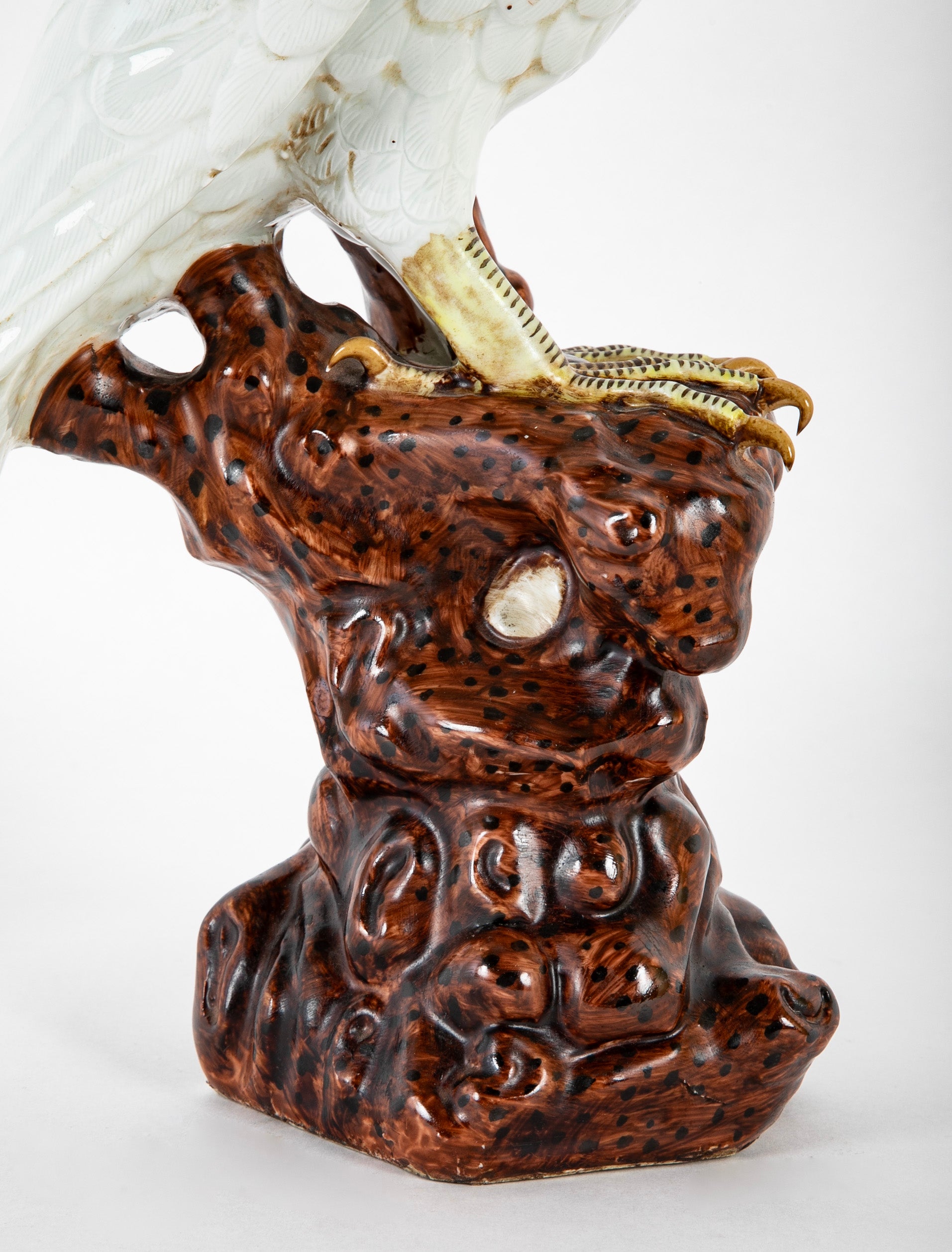 A Japanese White Glazed Porcelain Hawk Perched on a Tree Stump