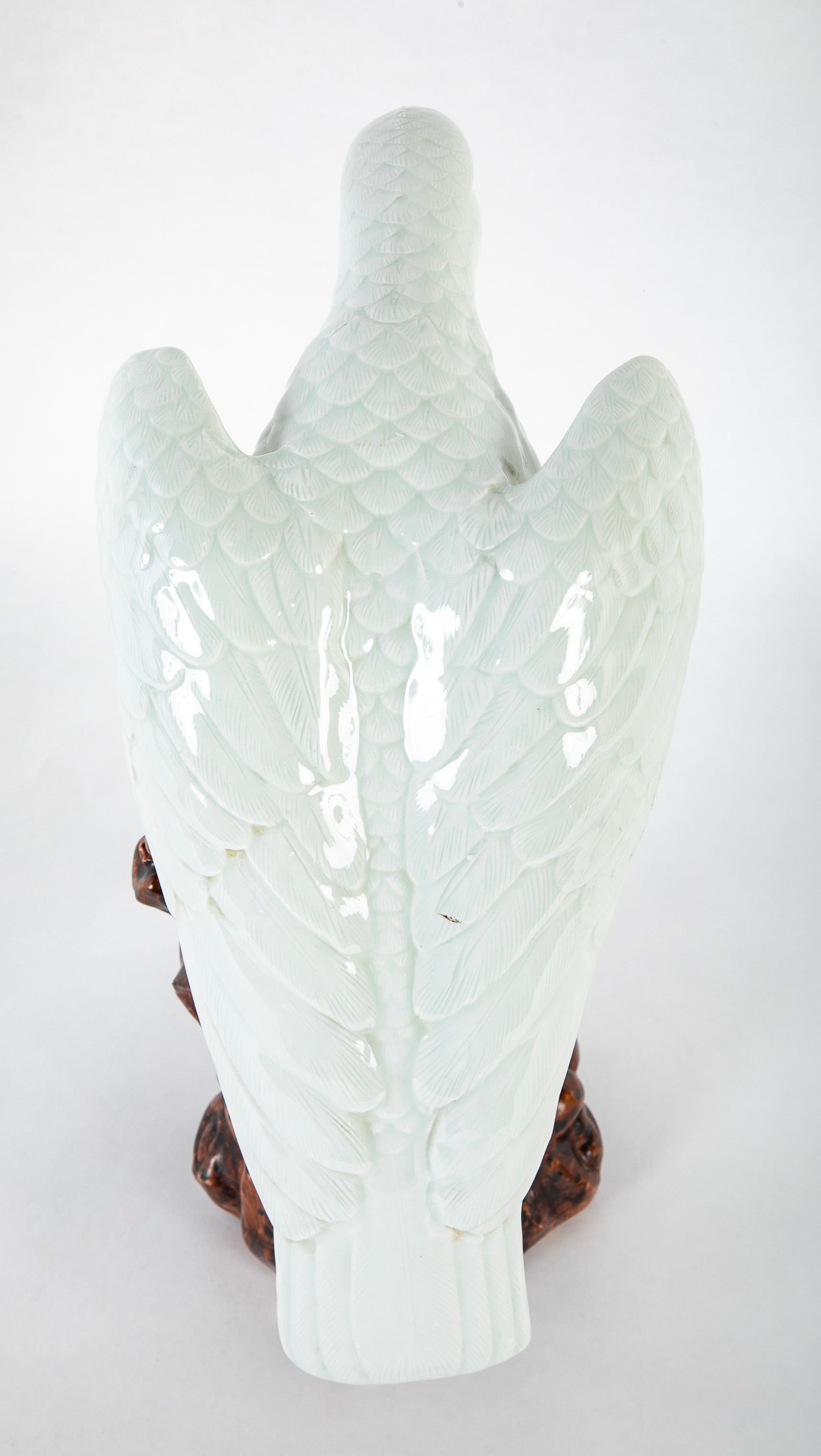 A Japanese White Glazed Porcelain Hawk Perched on a Tree Stump