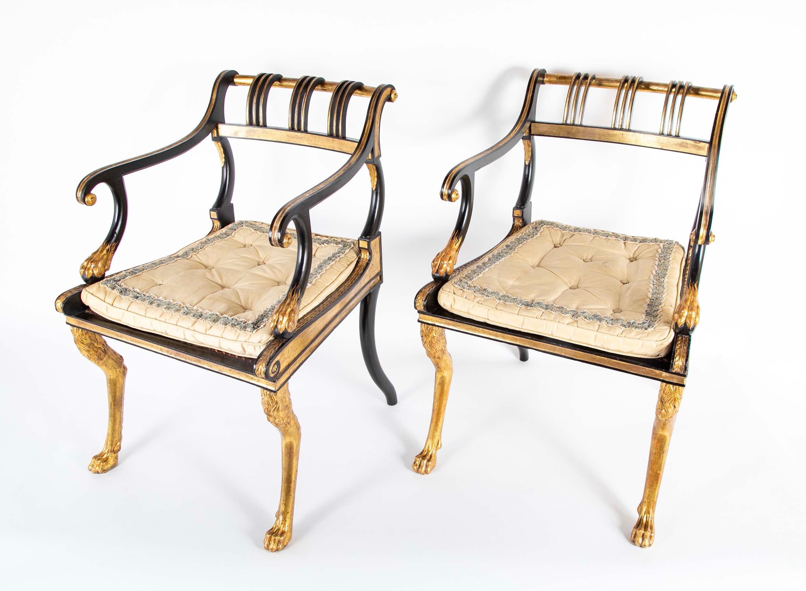 A Pair of Regency Style Ebonized and Parcel Gilt Armchairs