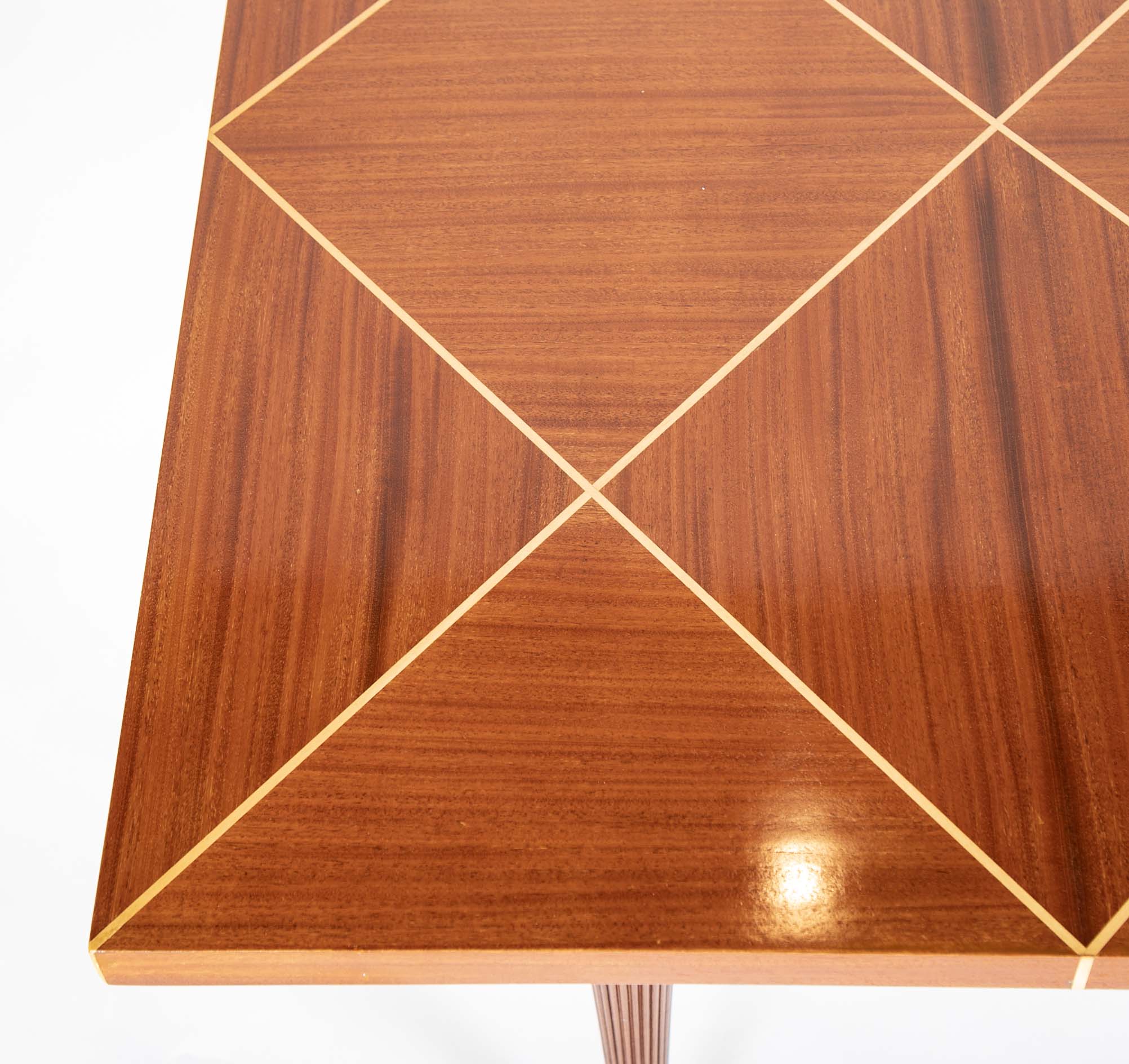 A Tommi Parzinger for Charak Modern Mahogany and Maple Dining Table with Leaves.