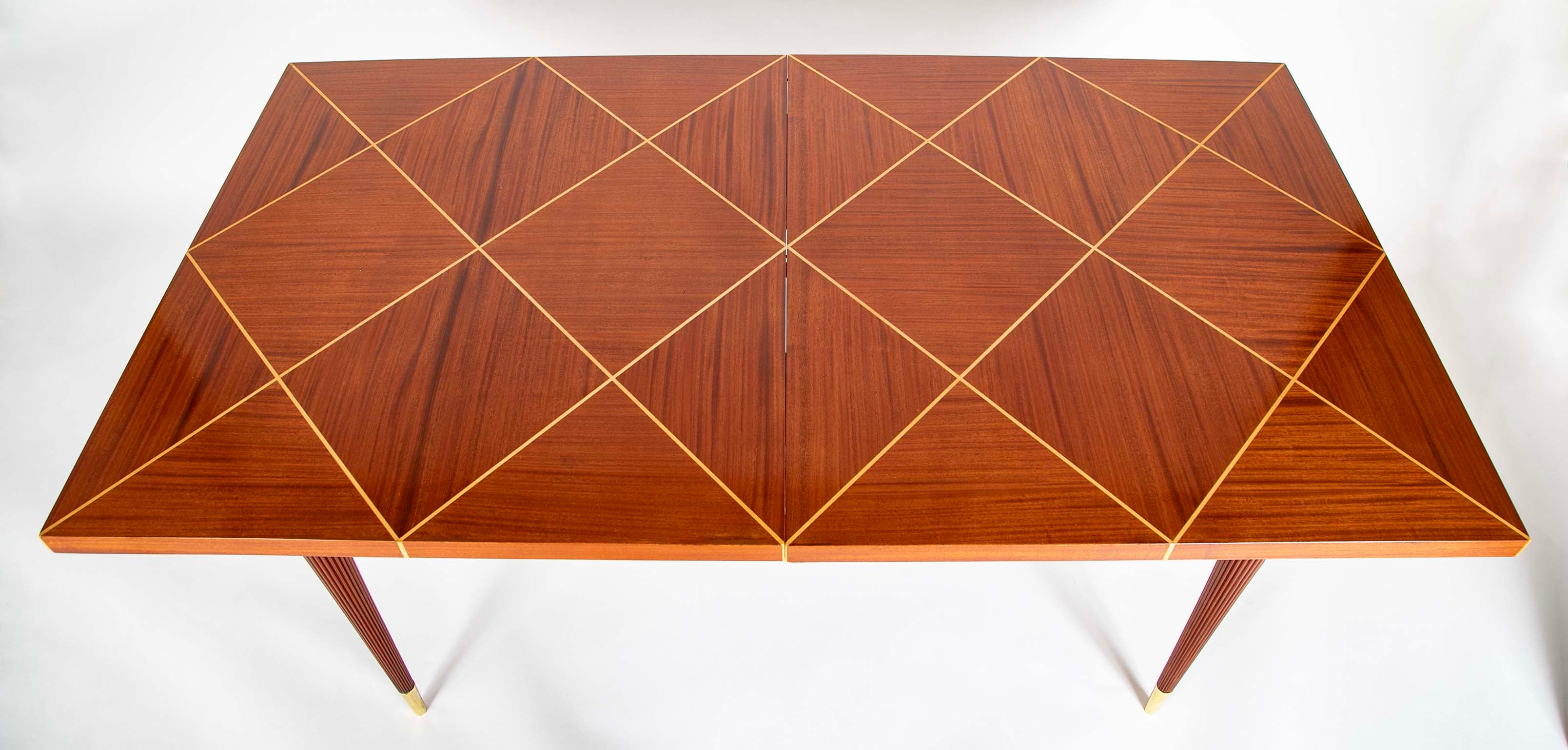 A Tommi Parzinger for Charak Modern Mahogany and Maple Dining Table with Leaves.