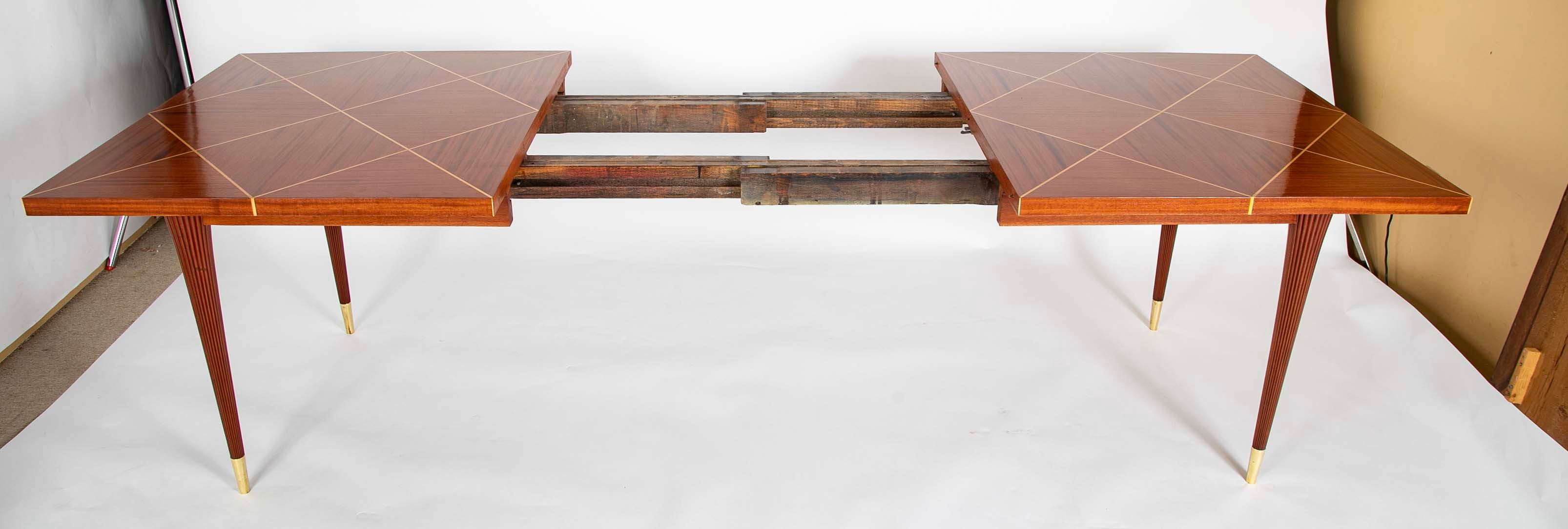 A Tommi Parzinger for Charak Modern Mahogany and Maple Dining Table with Leaves.