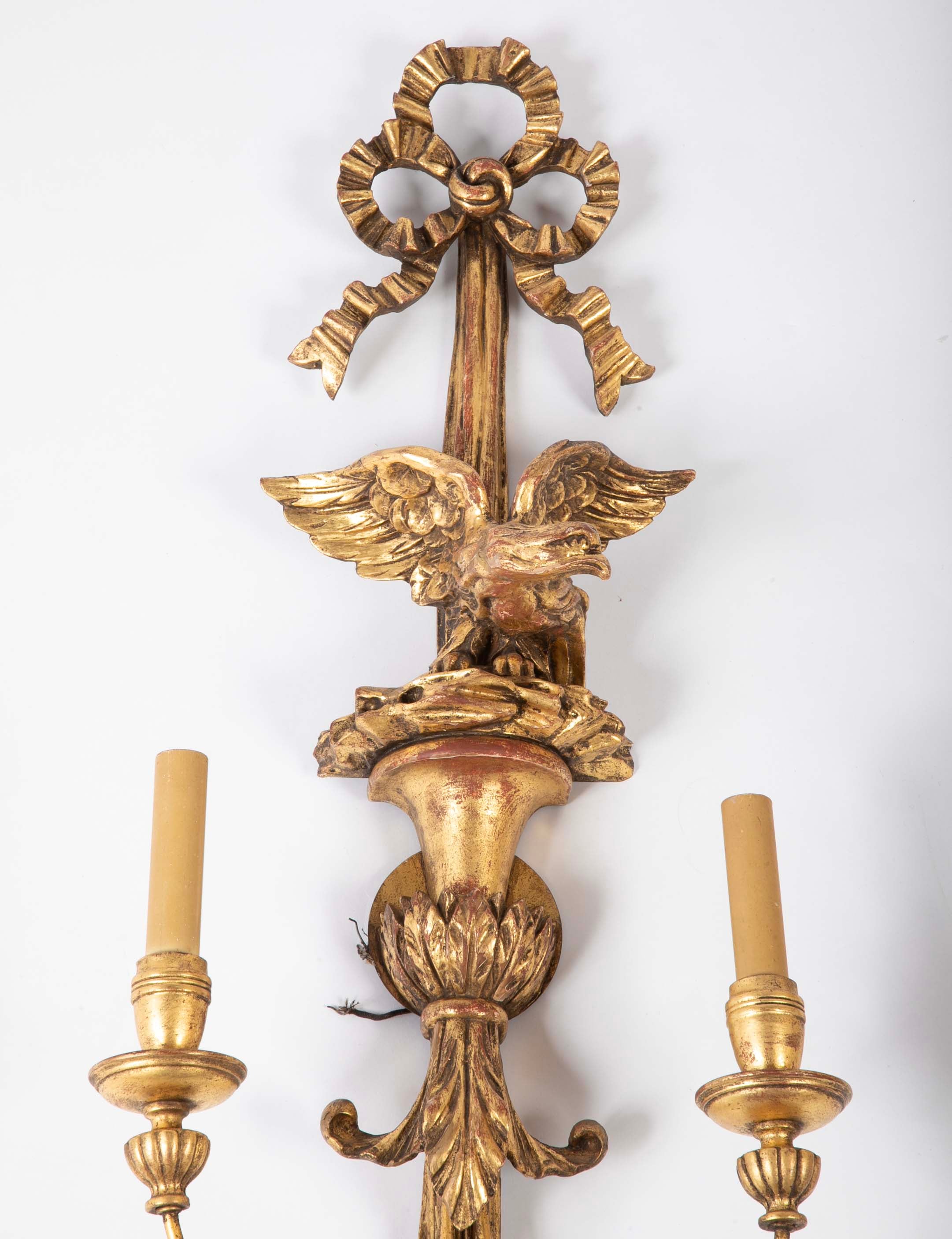 A Pair of Carved and Gilded Two Light Eagle Wall Sconces