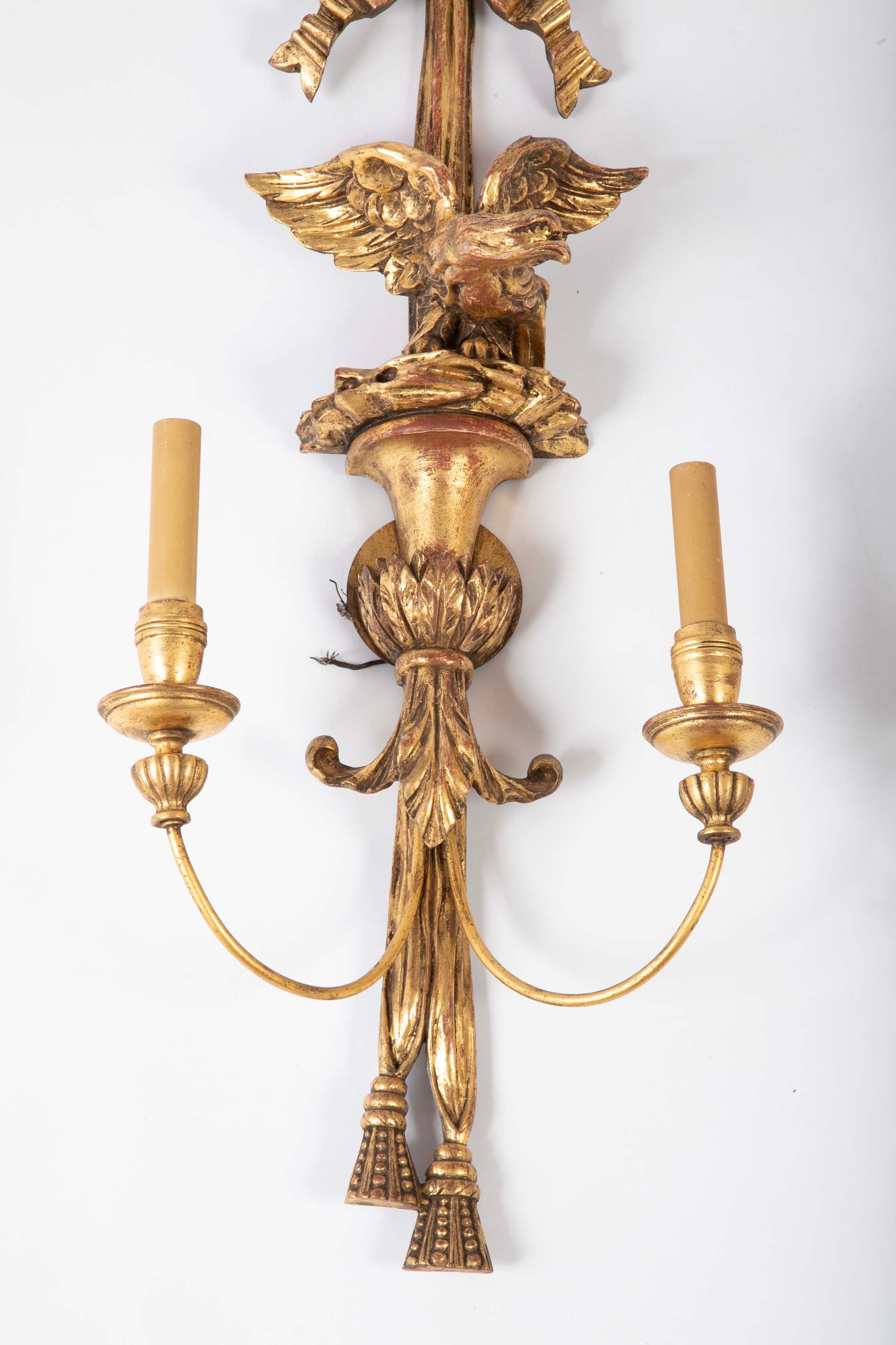 A Pair of Carved and Gilded Two Light Eagle Wall Sconces