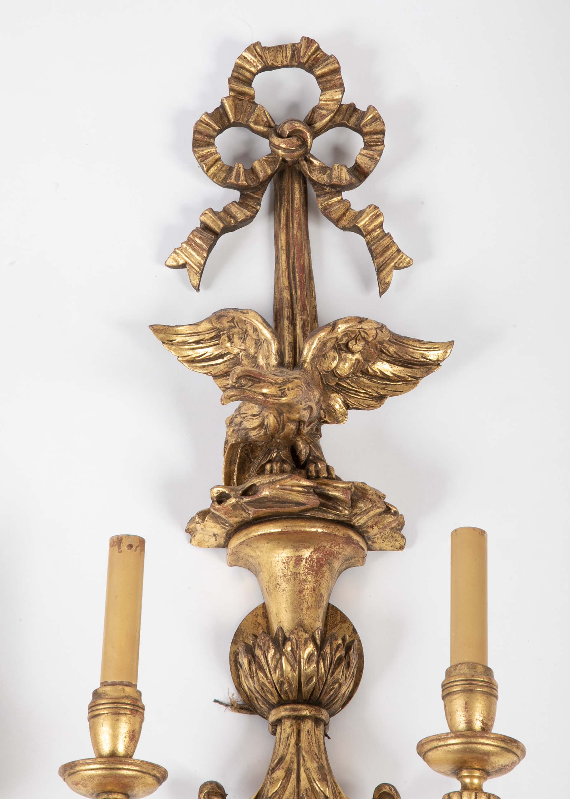A Pair of Carved and Gilded Two Light Eagle Wall Sconces