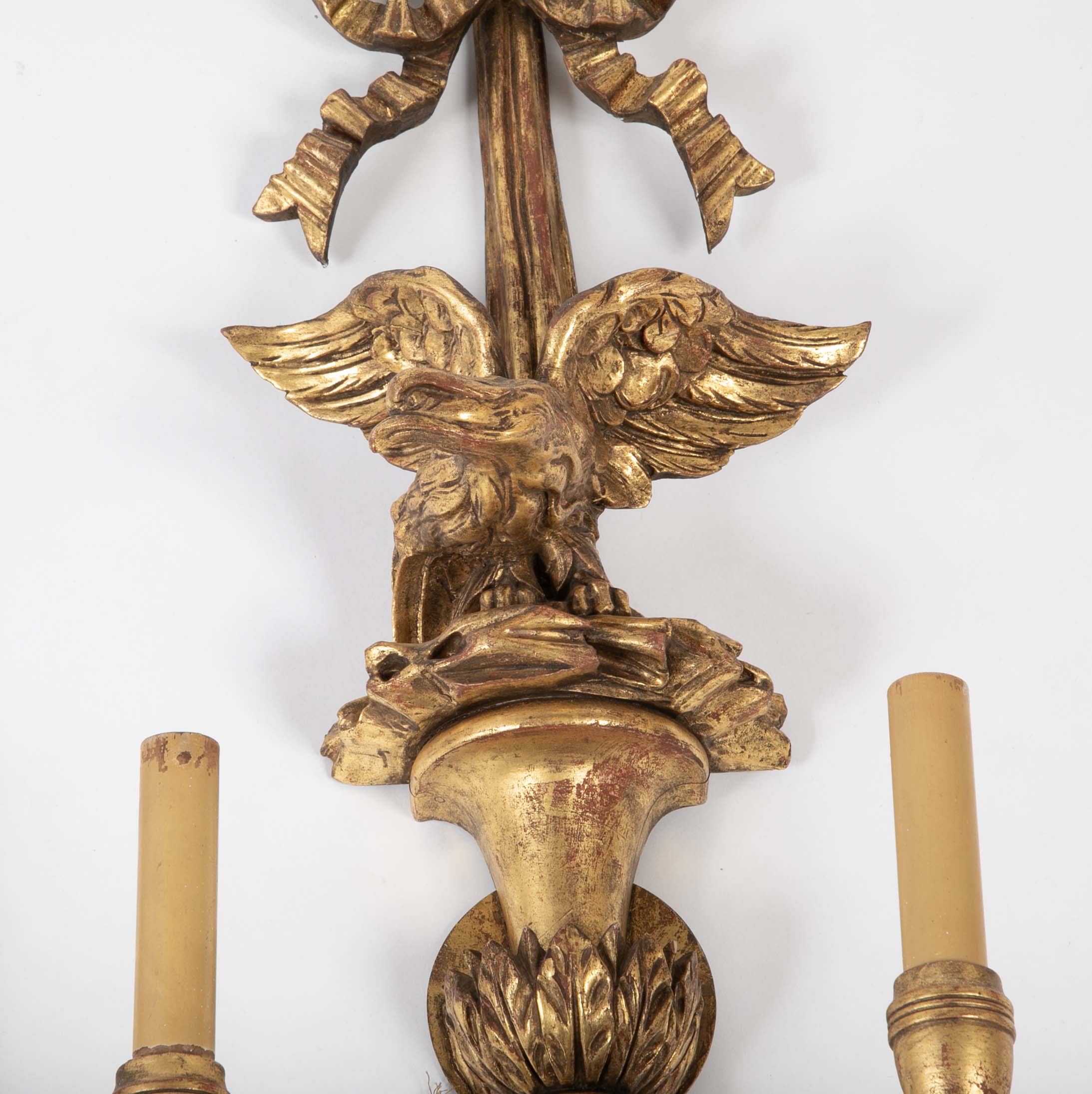 A Pair of Carved and Gilded Two Light Eagle Wall Sconces