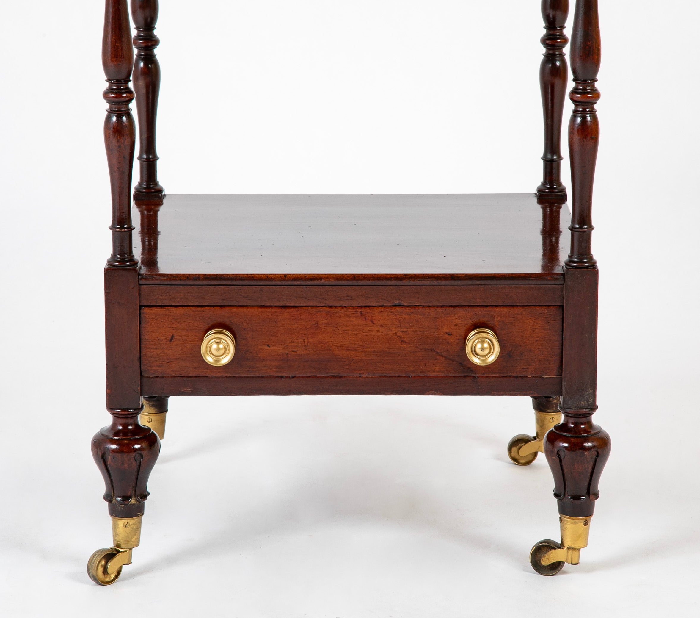 A Regency Four Tier Etagere with Rare Lotus Carved Legs