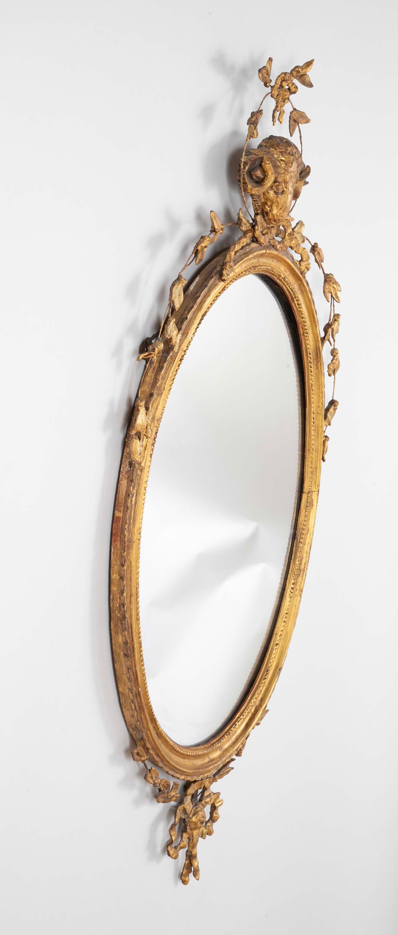 English George III Oval Hepplewhite Gilded Mirror with Ram's Head Surmount