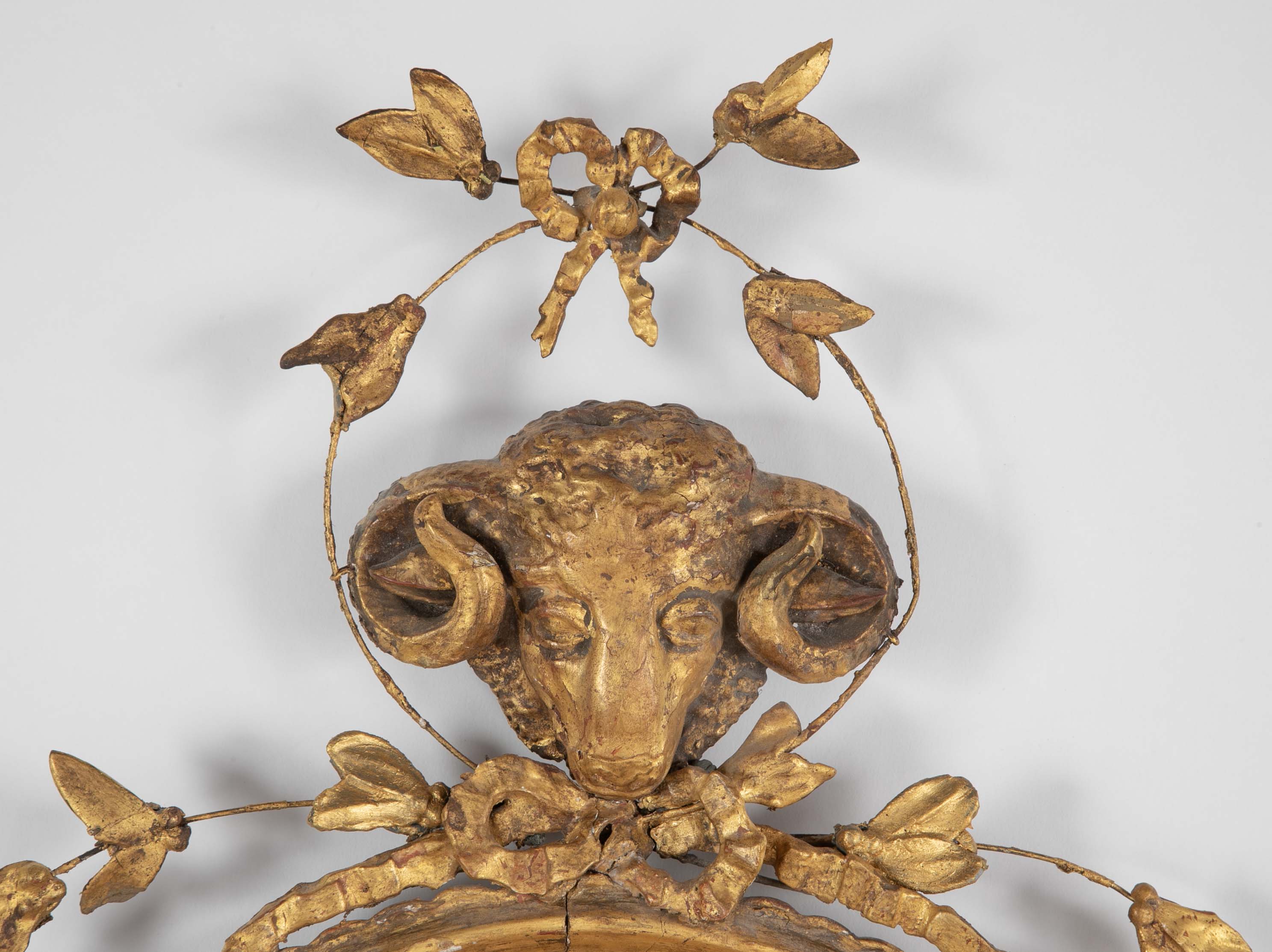 English George III Oval Hepplewhite Gilded Mirror with Ram's Head Surmount