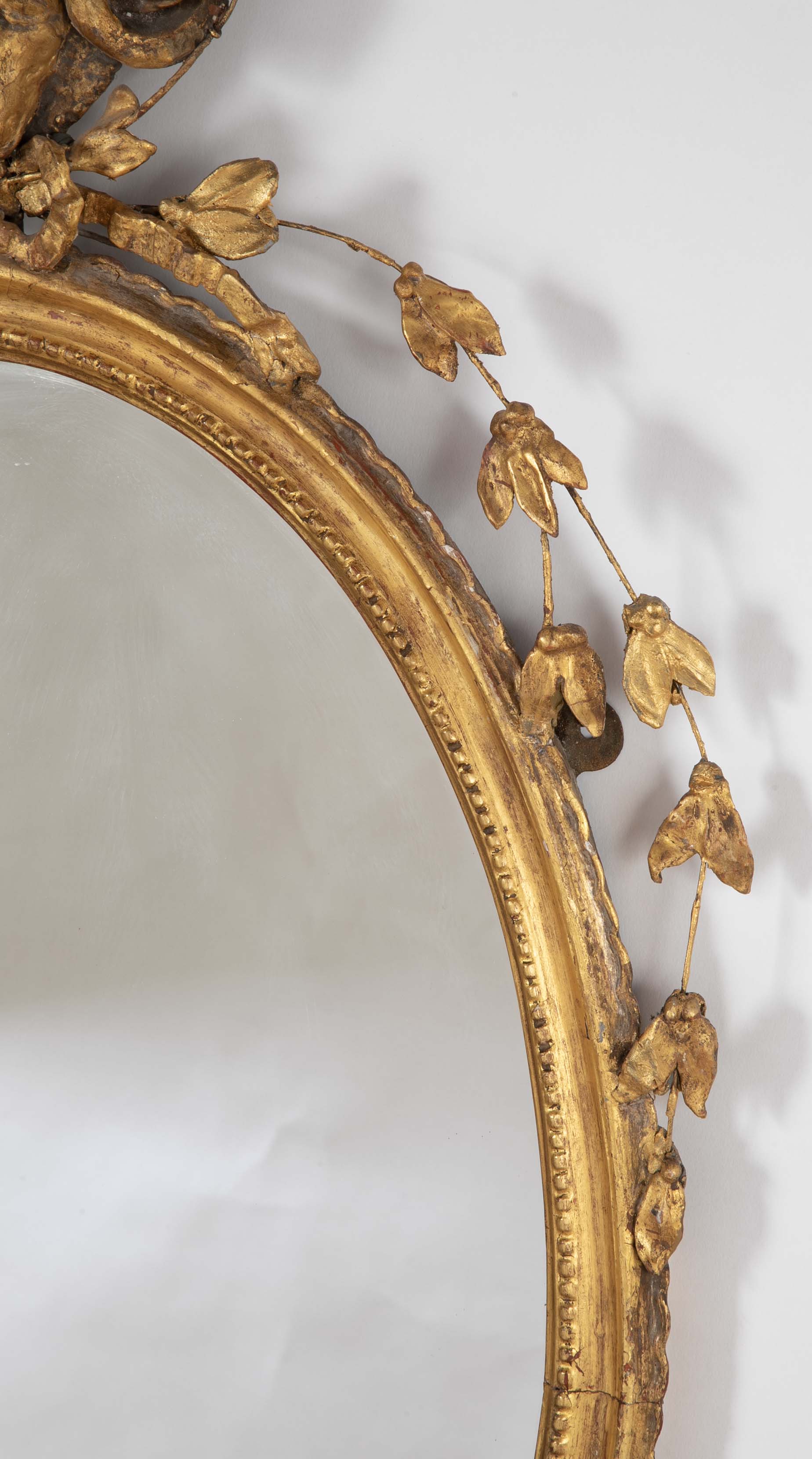 English George III Oval Hepplewhite Gilded Mirror with Ram's Head Surmount