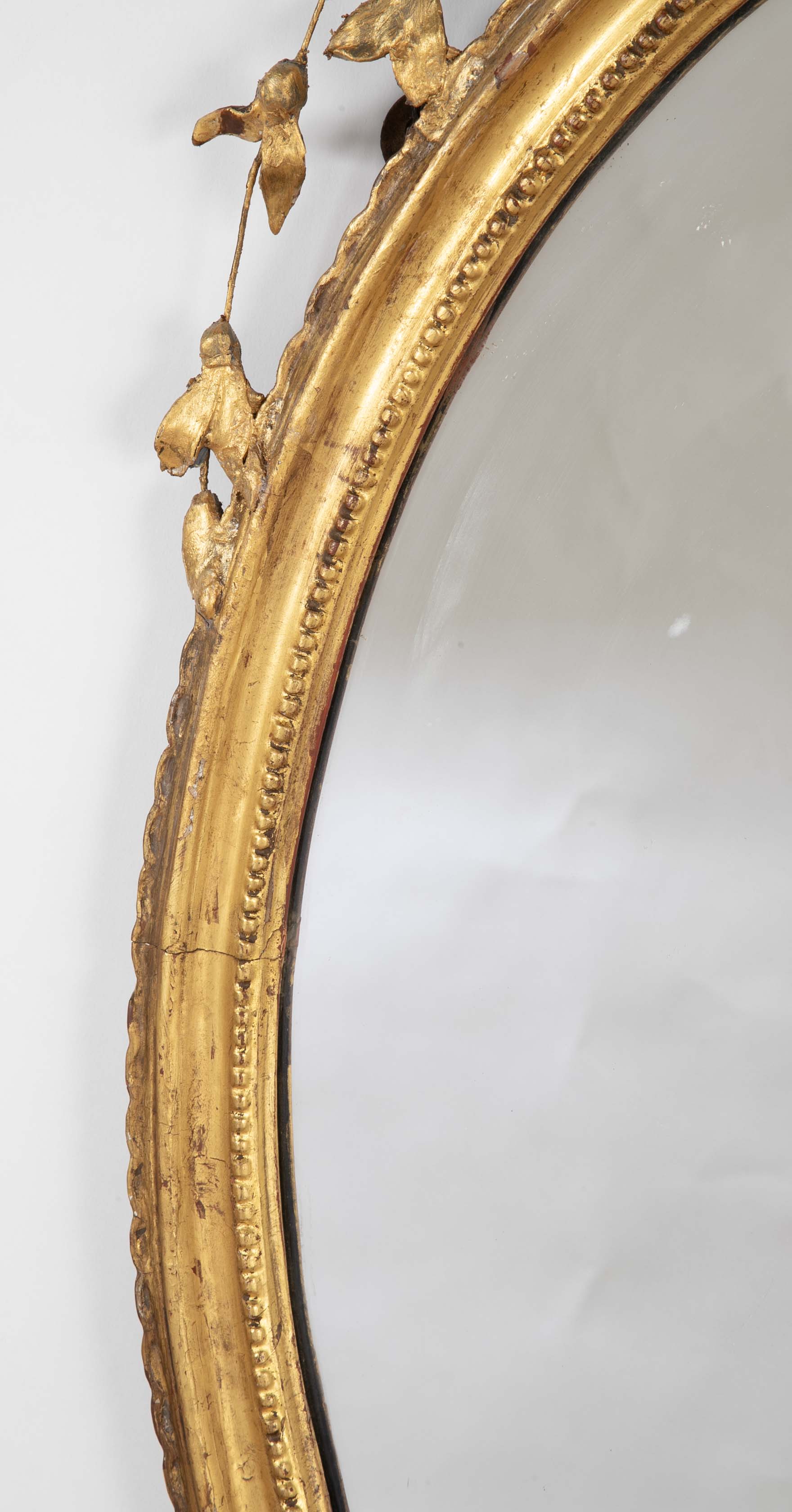 English George III Oval Hepplewhite Gilded Mirror with Ram's Head Surmount