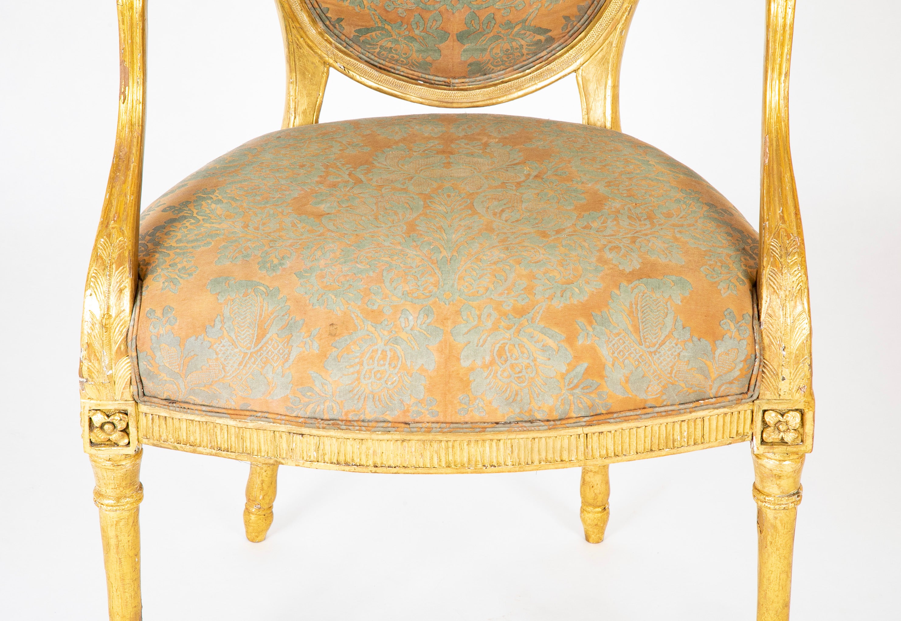 A Pair of George III Period Giltwood Oval Back "Elbow" Chairs