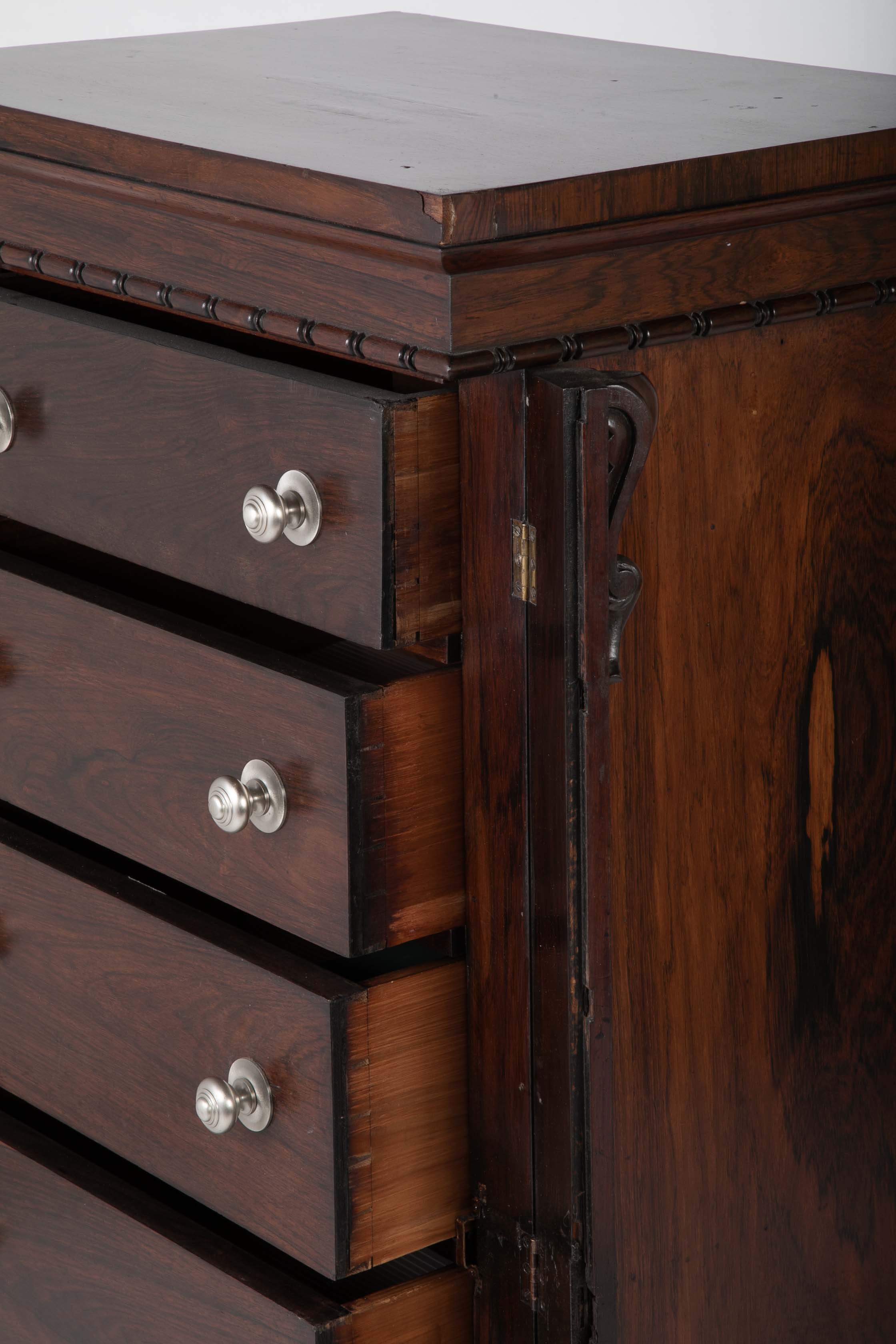A 19th Century Brazilian Rosewood Six Drawer Wellington High Cabinet