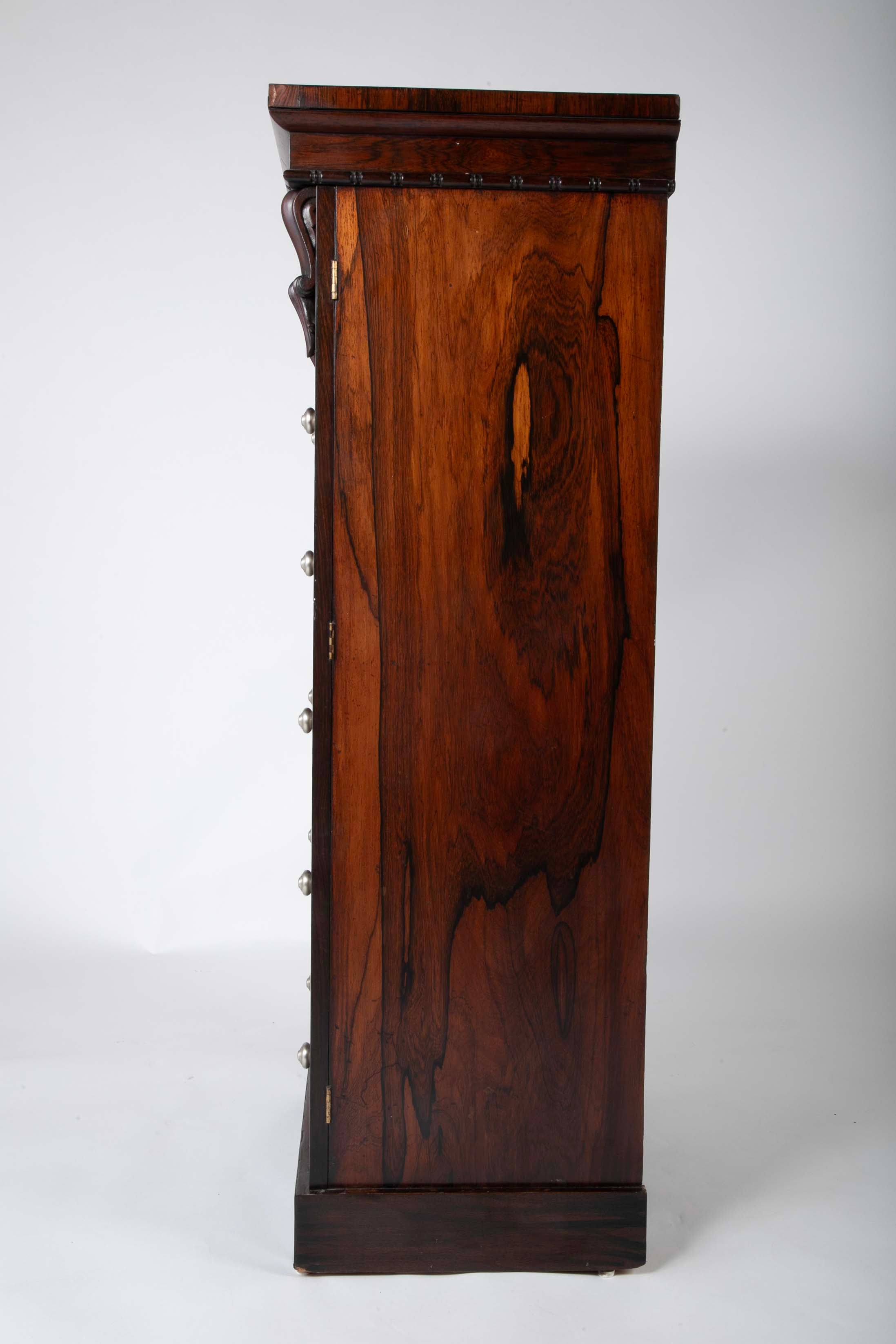 A 19th Century Brazilian Rosewood Six Drawer Wellington High Cabinet