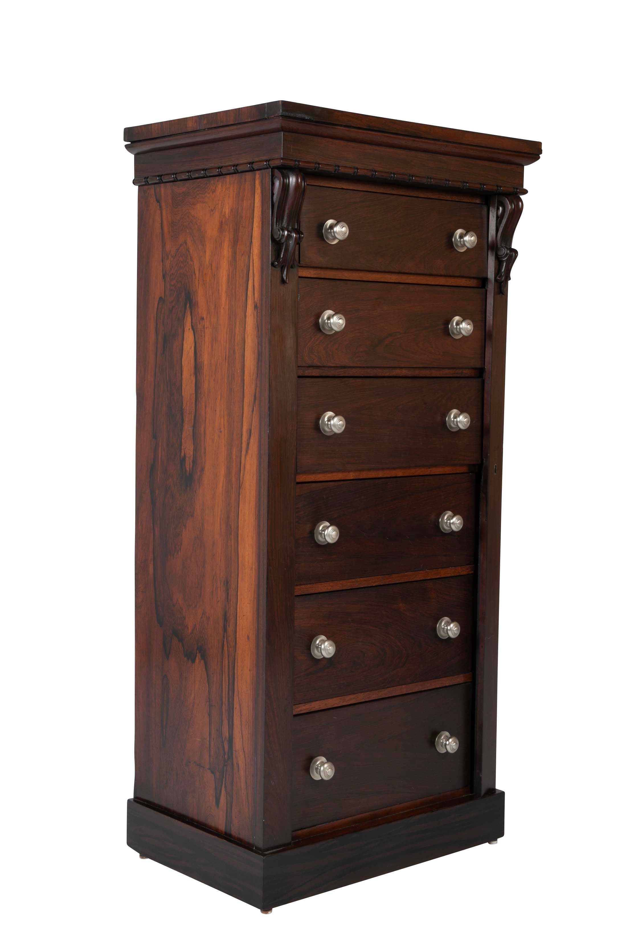 A 19th Century Brazilian Rosewood Six Drawer Wellington High Cabinet