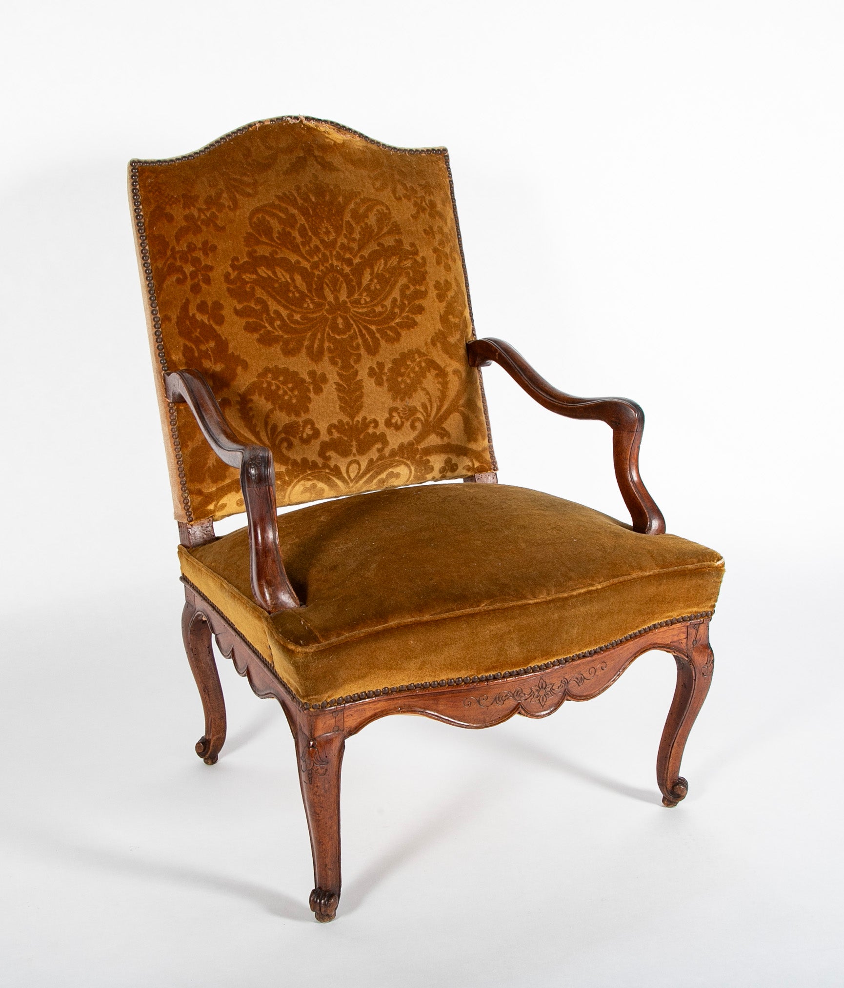 A Pair of French Carved Walnut Louis XIV Armchairs