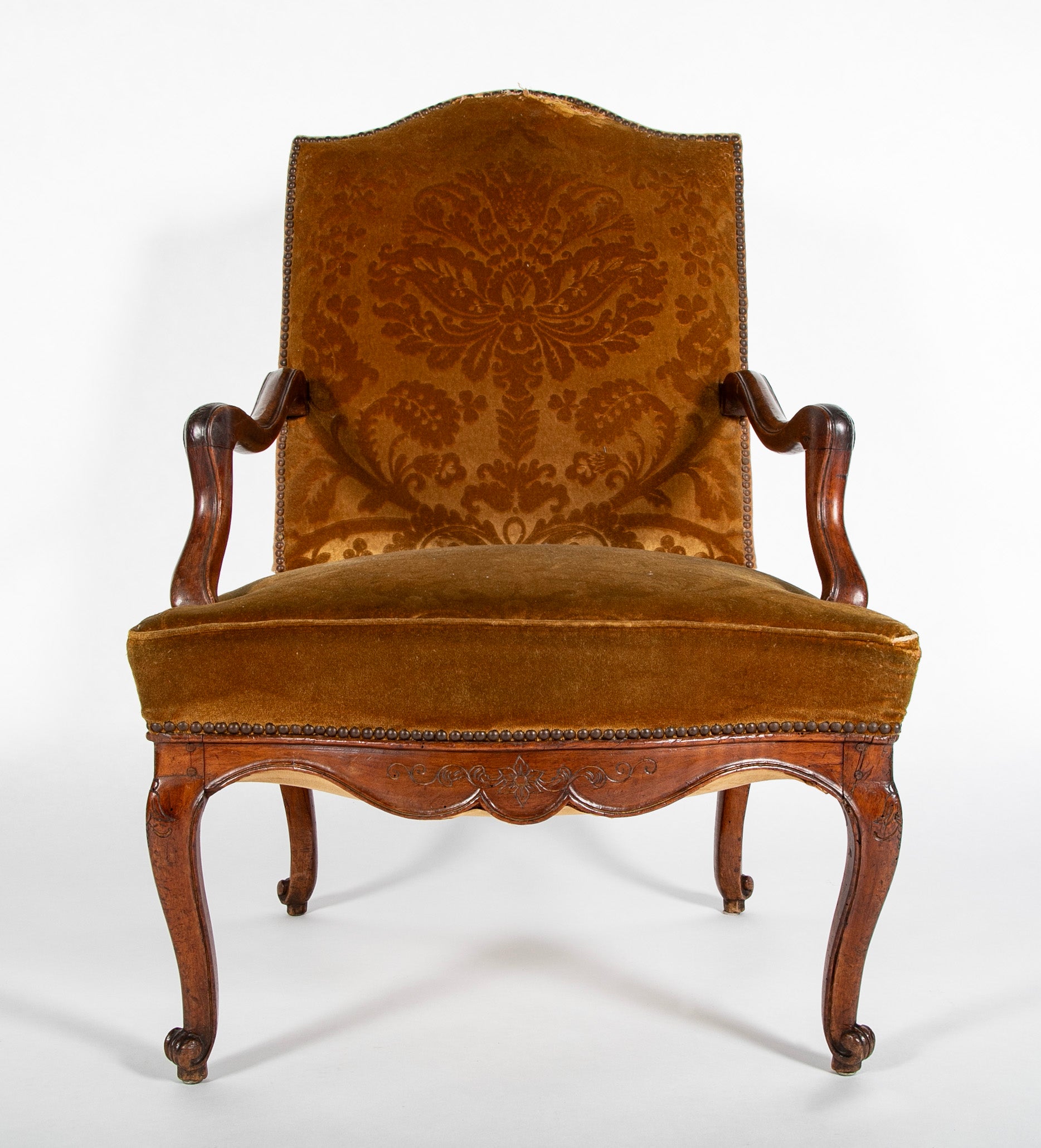 A Pair of French Carved Walnut Louis XIV Armchairs