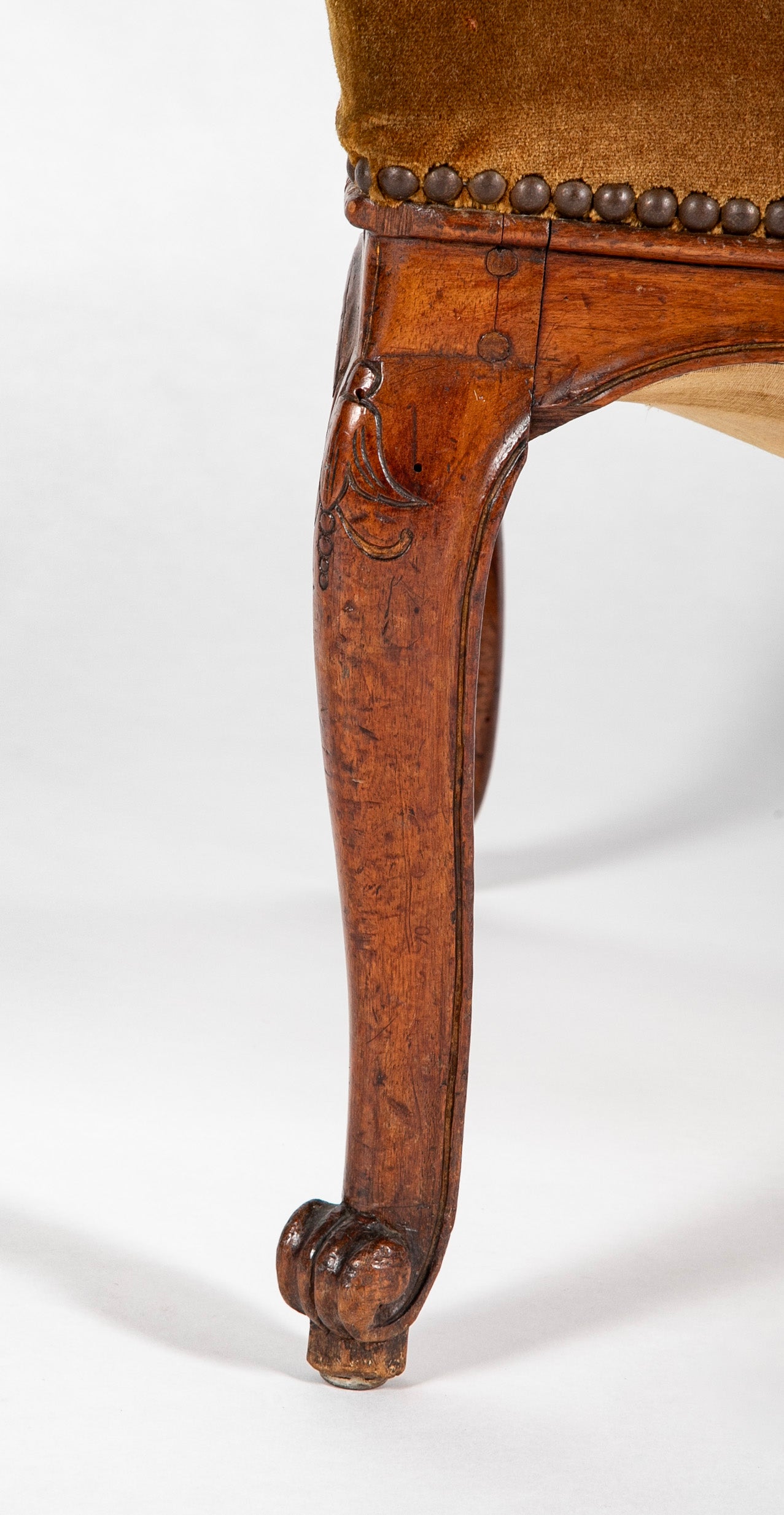 A Pair of French Carved Walnut Louis XIV Armchairs