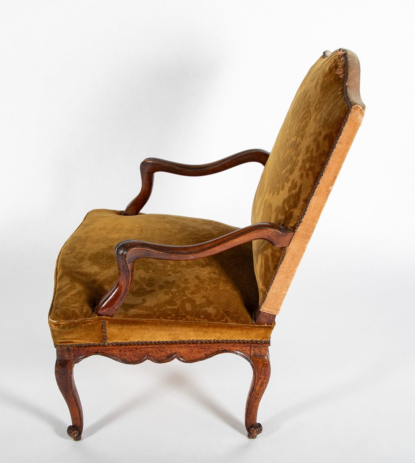 A Pair of French Carved Walnut Louis XIV Armchairs