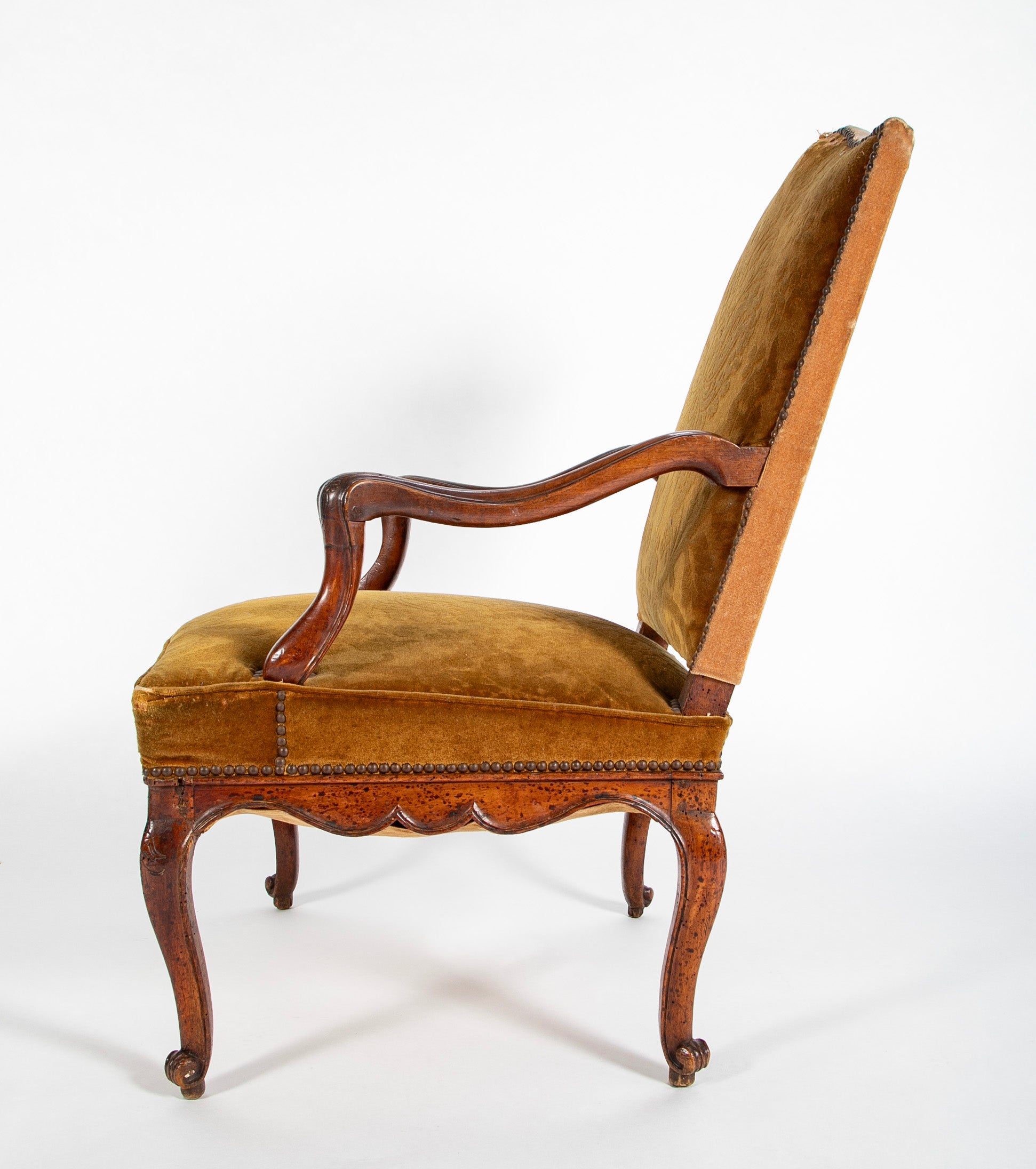 A Pair of French Carved Walnut Louis XIV Armchairs