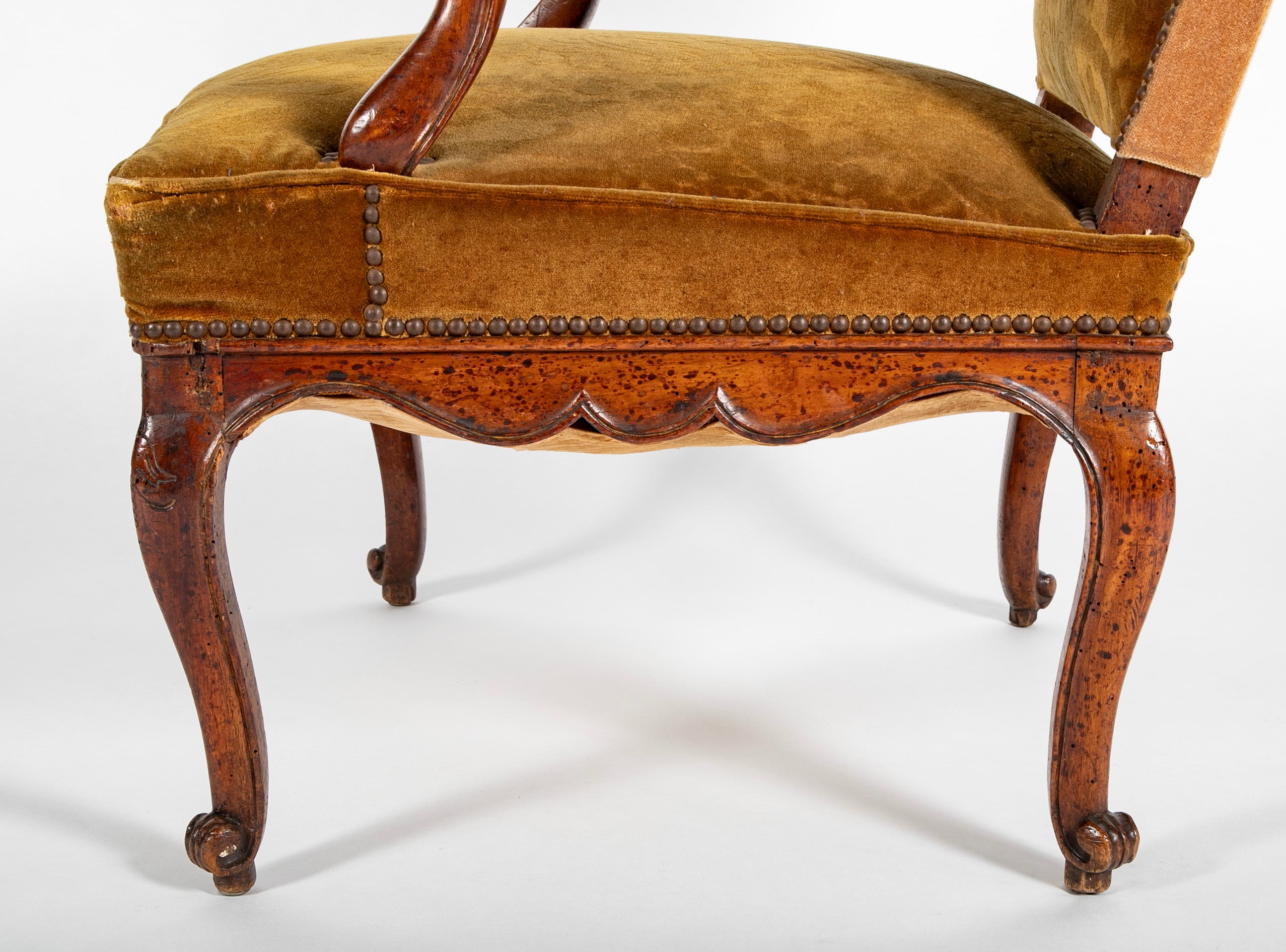 A Pair of French Carved Walnut Louis XIV Armchairs