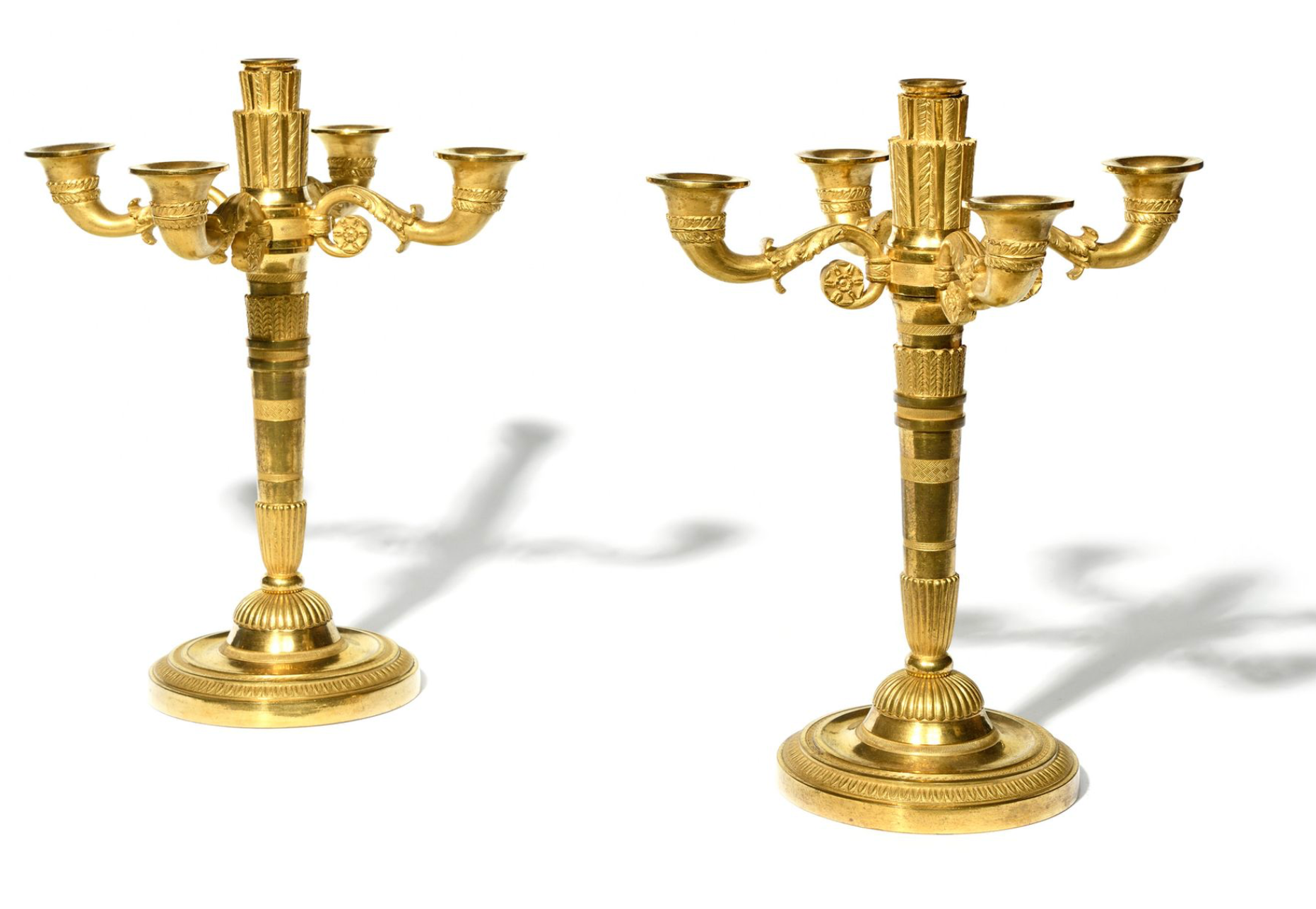 A Pair of Period Empire Gilt Bronze Candlesticks.