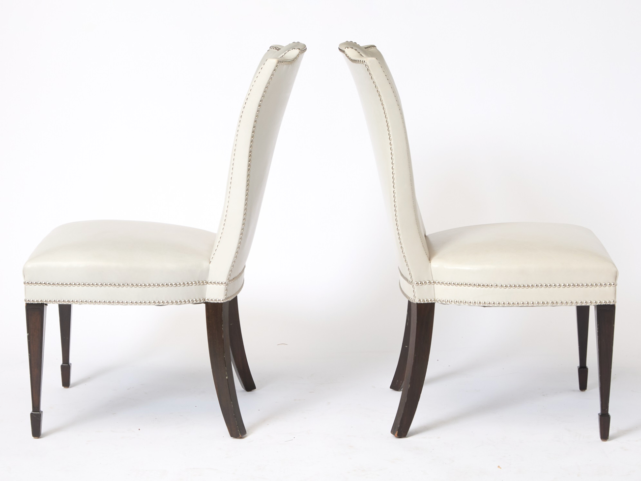 A Set of 12 Leather and Close Chrome Nailed Dining Chairs