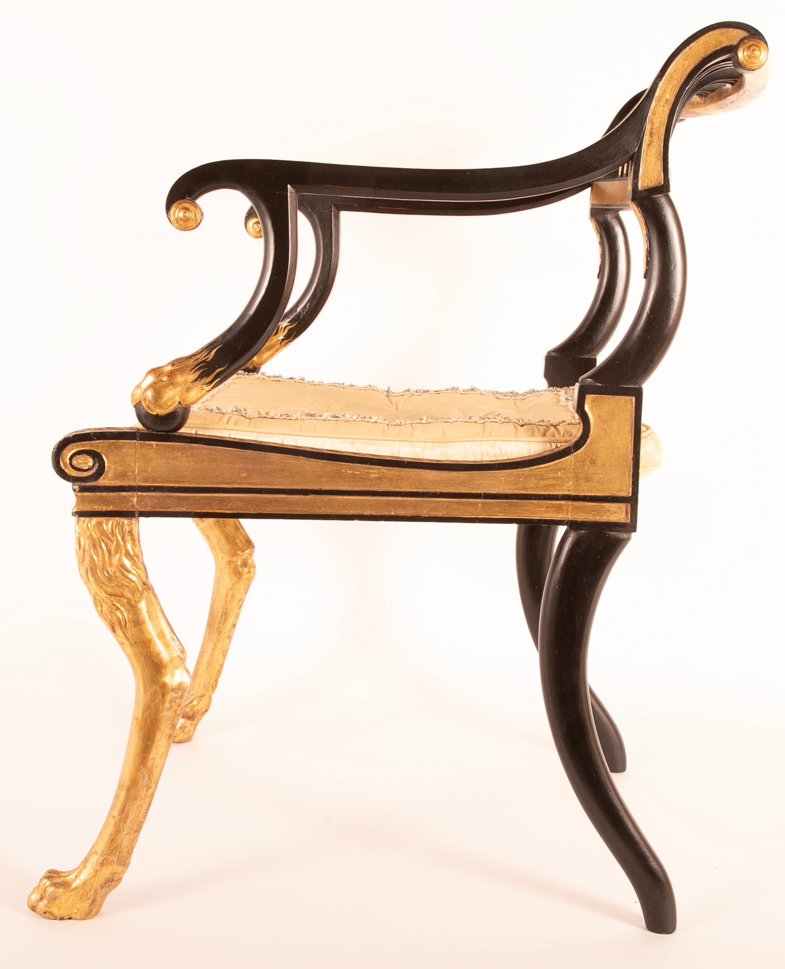 A Pair of Regency Style Ebonized and Parcel Gilt Armchairs