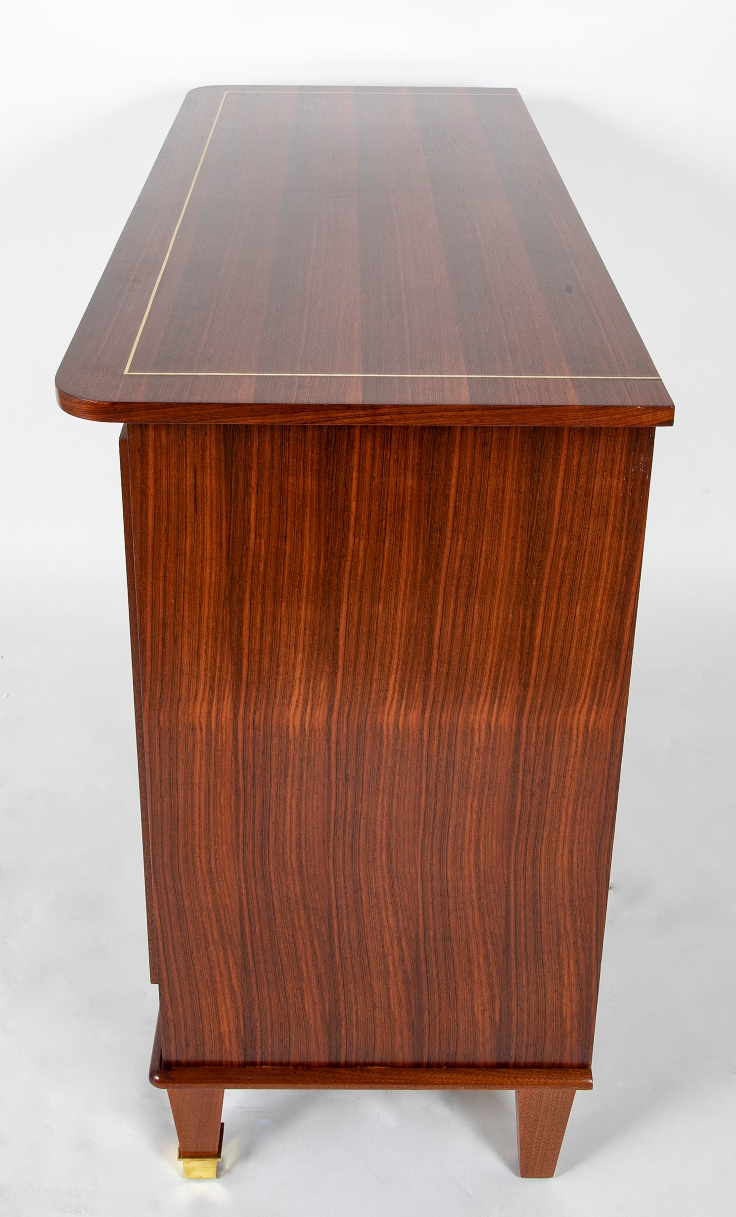 A Three Drawer Rosewood Commode in the Manner of Jacques Adnet