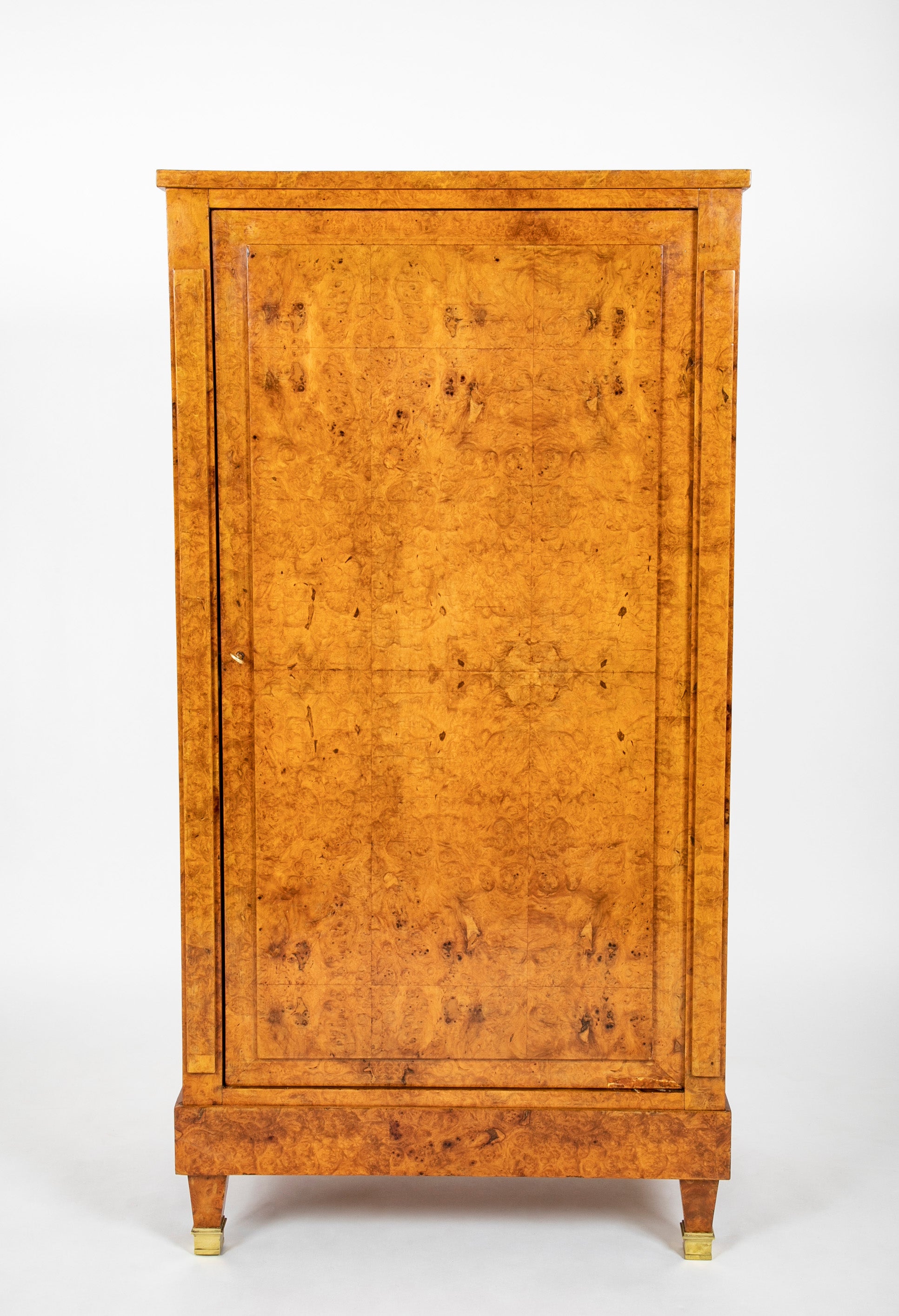 A French Burlwood Cabinet on Bronze Sabots