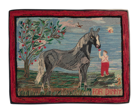 An Exceptional American Hooked Rug Depicting a Boy Feeding an Apple to a Horse