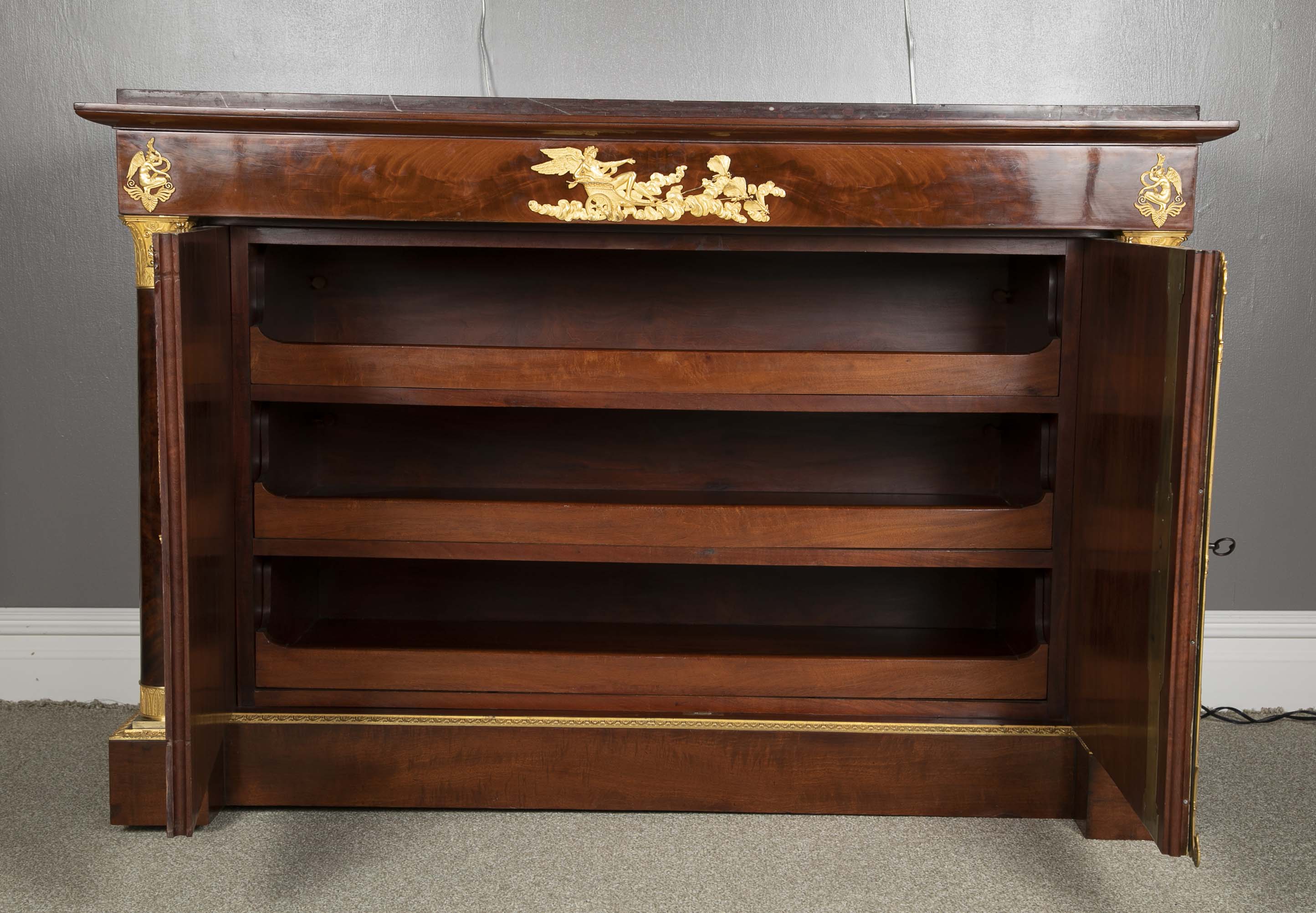 A Molitor French Empire Flame Mahogany and Gilt Bronze Commode with Rouge Griotte