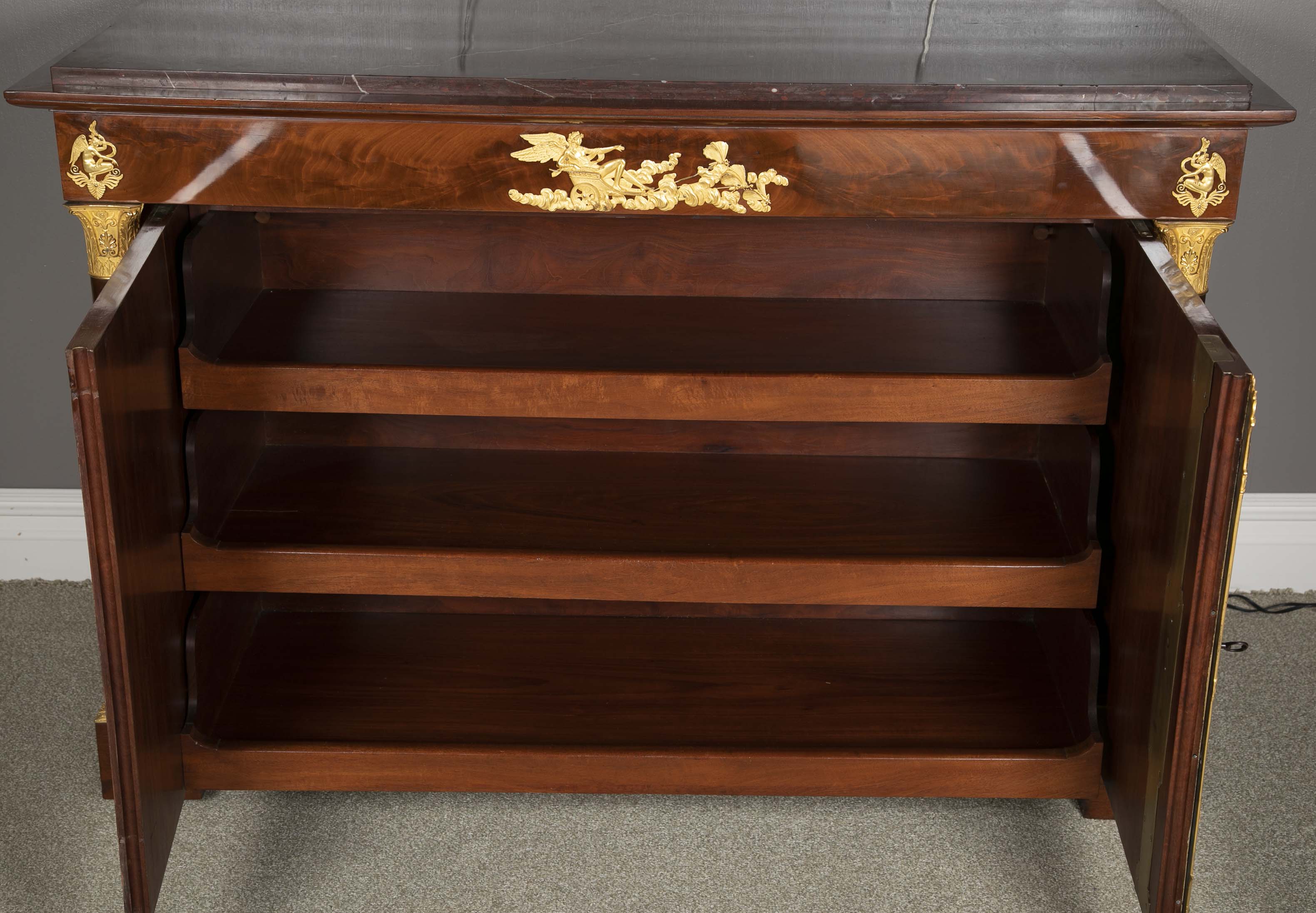 A Molitor French Empire Flame Mahogany and Gilt Bronze Commode with Rouge Griotte