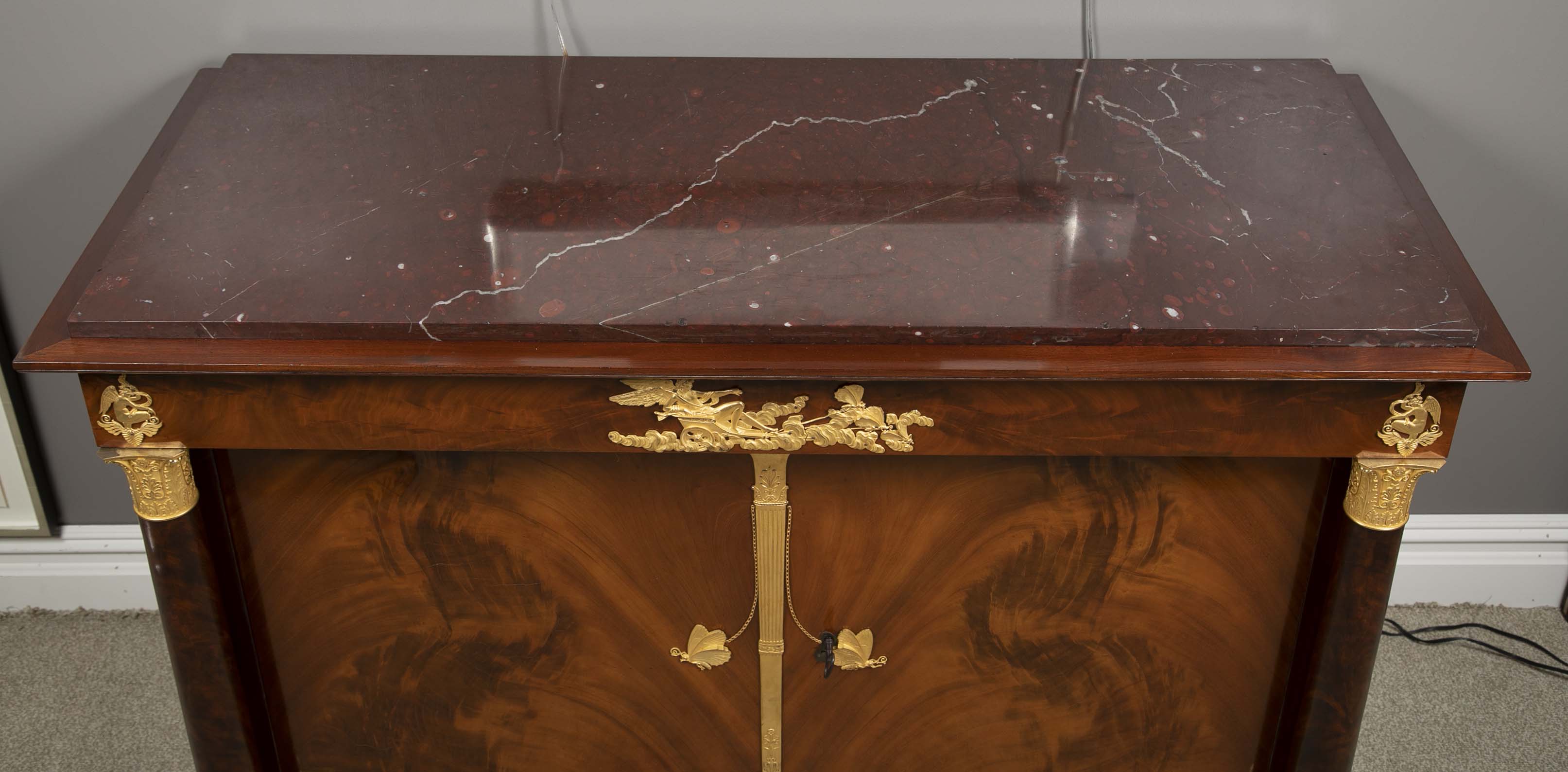 A Molitor French Empire Flame Mahogany and Gilt Bronze Commode with Rouge Griotte