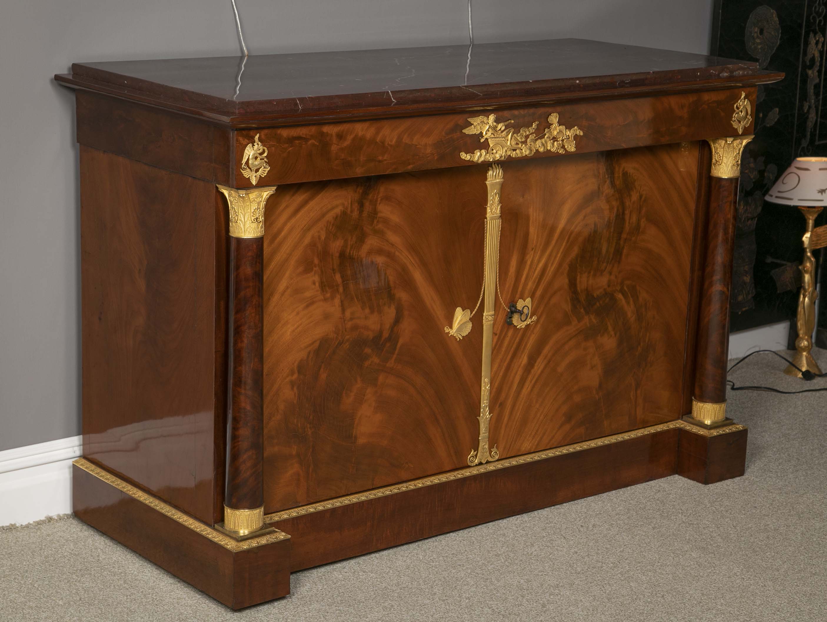 A Molitor French Empire Flame Mahogany and Gilt Bronze Commode with Rouge Griotte
